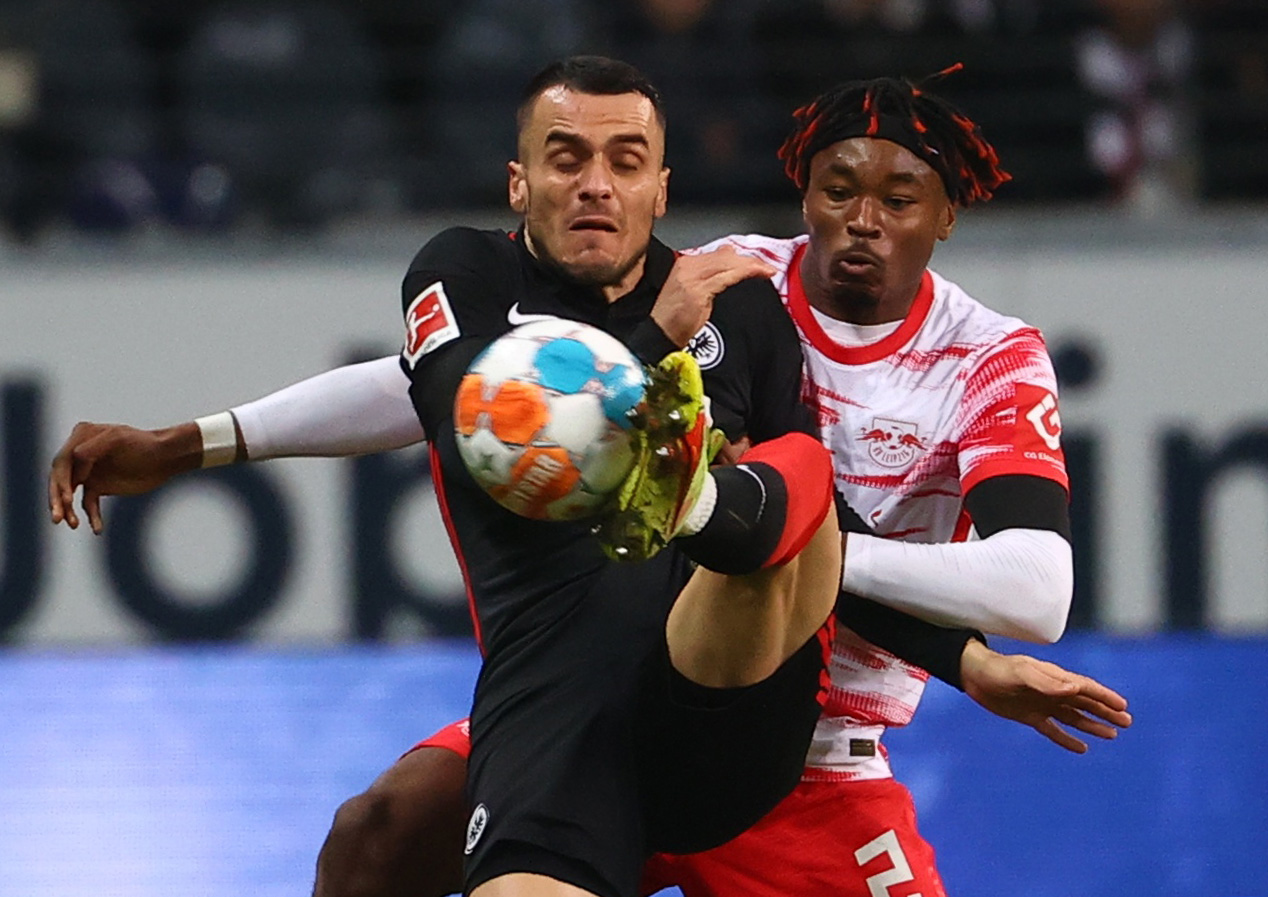 Soccer Football - Bundesliga - Eintracht Frankfurt v RB Leipzig - Deutsche Bank Park, Frankfurt, Germany - October 30, 2021   Eintracht Frankfurt's Filip Kostic in action with RB Leipzig's Mohamed Simakan REUTERS