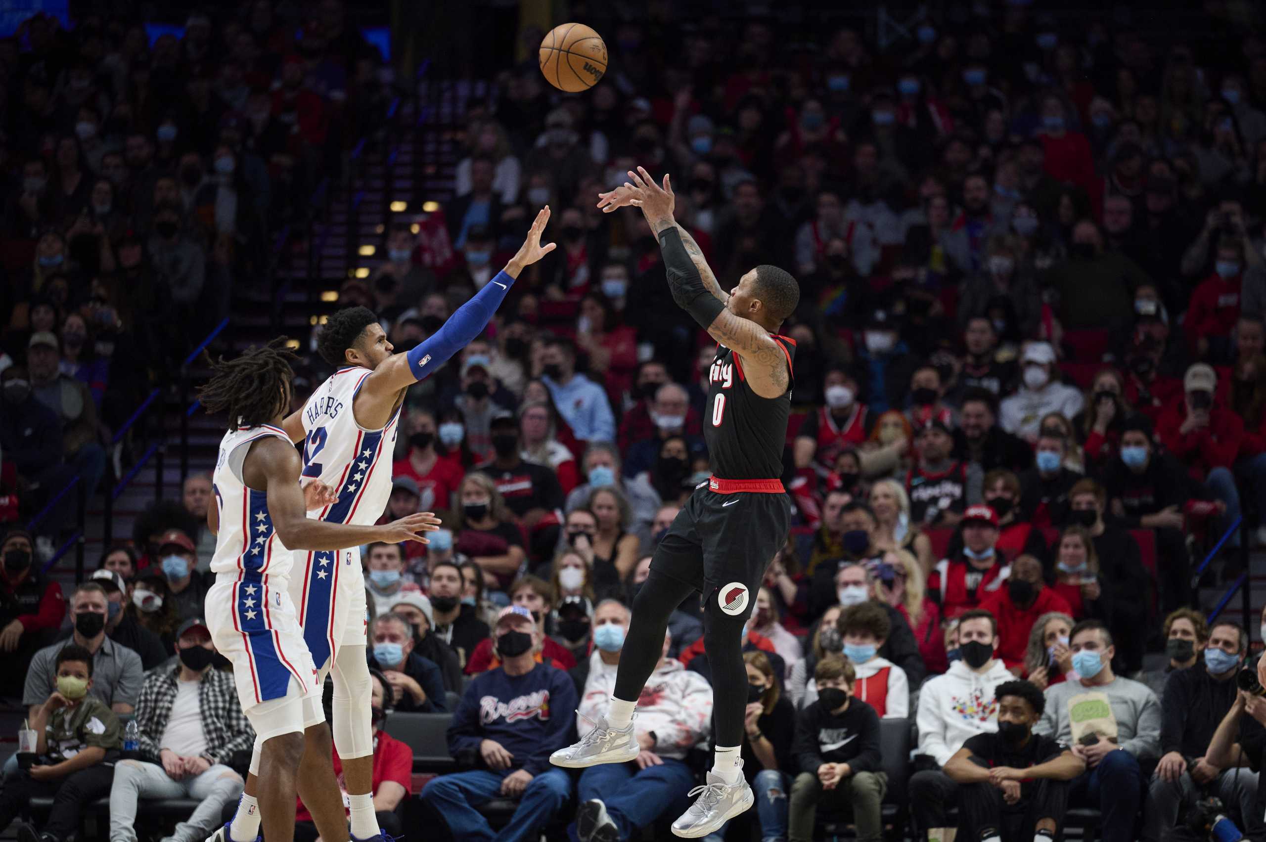 Nov 20, 2021; Portland, Oregon, USA; Portland Trail Blazers guard Damian Lillard (0) shoots a three pointe basket during the second half against Philadelphia 76ers forward Tobias Harris (12) at Moda Center. The Trail Blazers won 118-111. Mandatory Credit: Troy Wayrynen-USA TODAY Sports