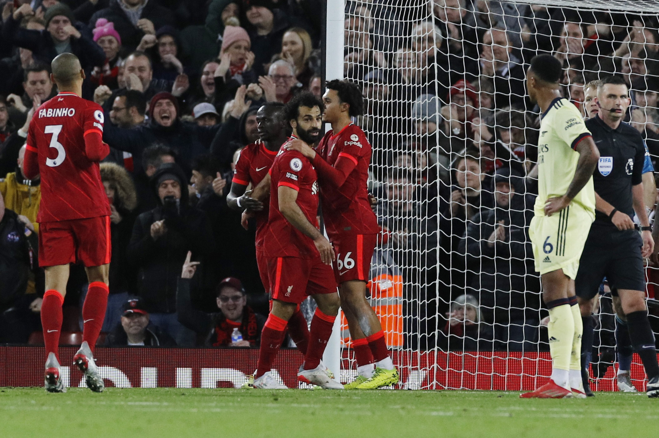 Soccer Football - Premier League - Liverpool v Arsenal - Anfield, Liverpool, Britain - November 20, 2021 Liverpool's Mohamed Salah celebrates scoring their third goal with Trent Alexander-Arnold and Sadio Mane Action Images via Reuters