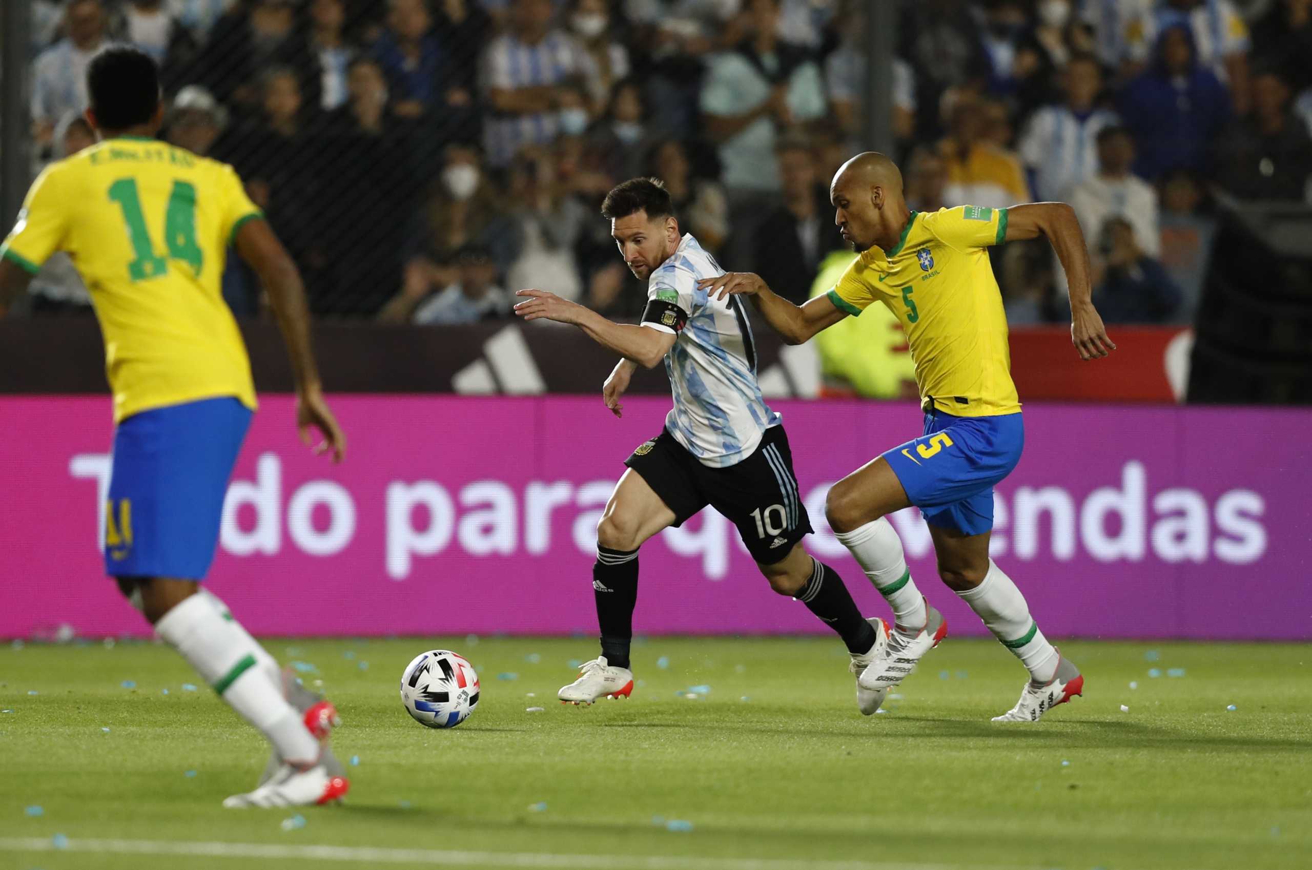 Soccer Football - World Cup - South American Qualifiers - Argentina v Brazil - Estadio San Juan del Bicentenario, San Juan, Argentina - November 16, 2021 Argentina's Lionel Messi in action with Brazil's Edenilson REUTERS