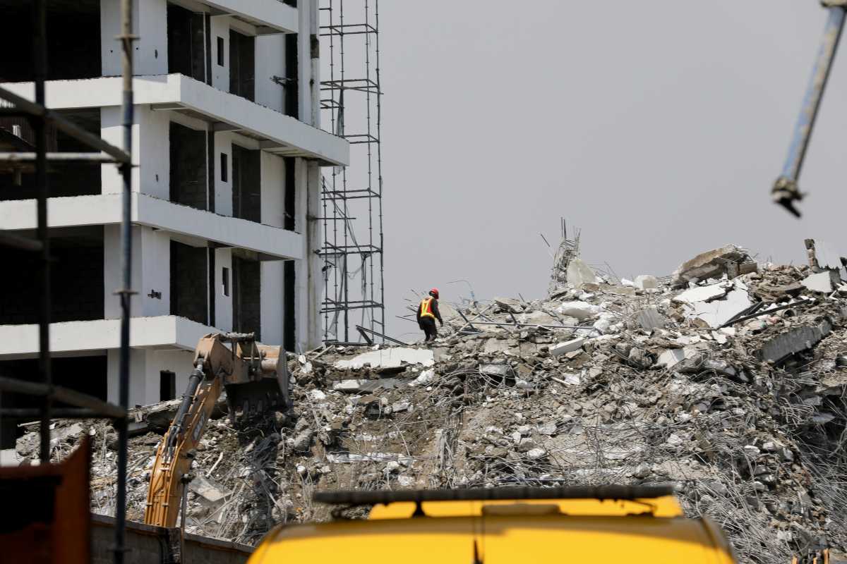 A rescue member works on the debris as search and rescue efforts continue at the site of a collapsed building in Ikoyi, Lagos, Nigeria November 2, 2021. REUTERS