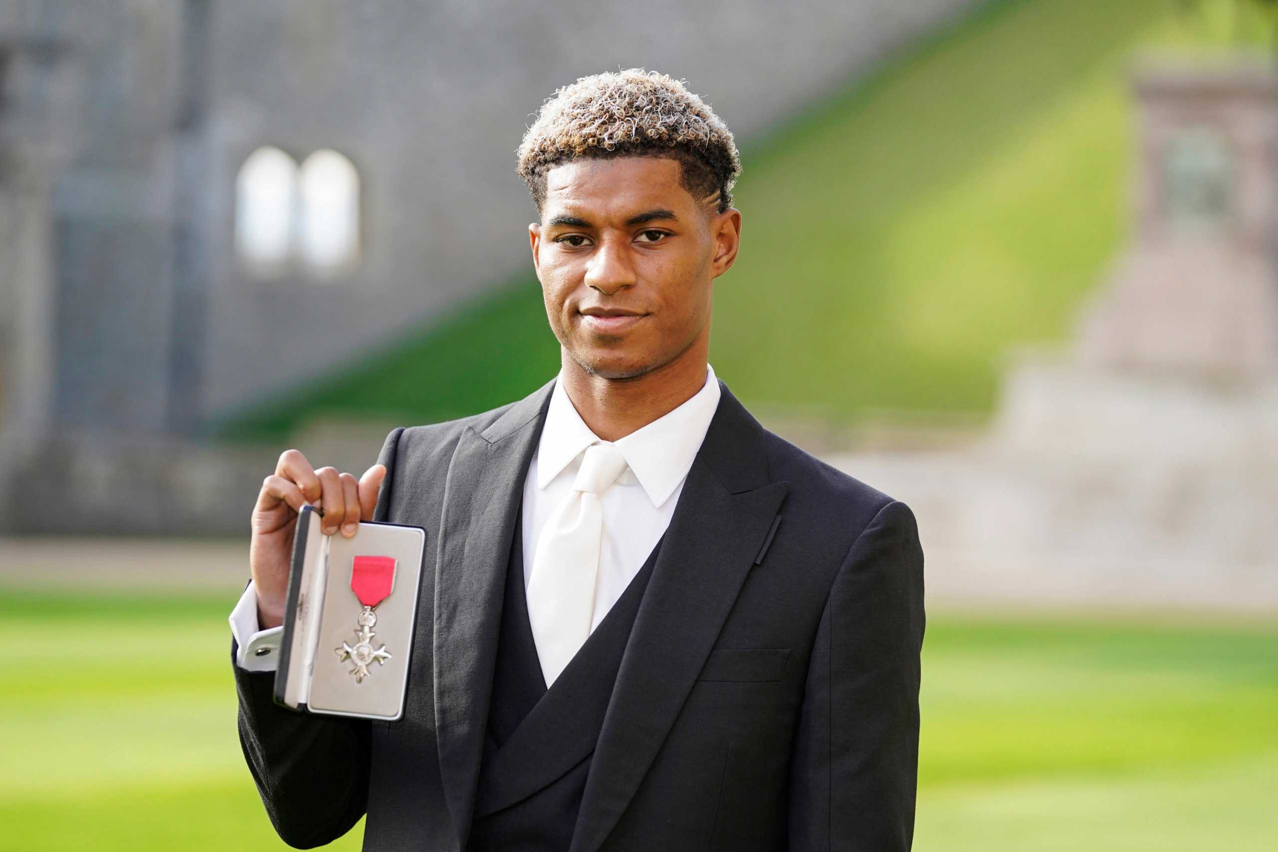 Footballer Marcus Rashford poses after receiving his Most Excellent Order of the British Empire (MBE) for services to vulnerable children in the UK during the coronavirus disease (COVID-19) pandemic, at an investiture ceremony at Windsor Castle, Britain November 9, 2021. Andrew Matthews