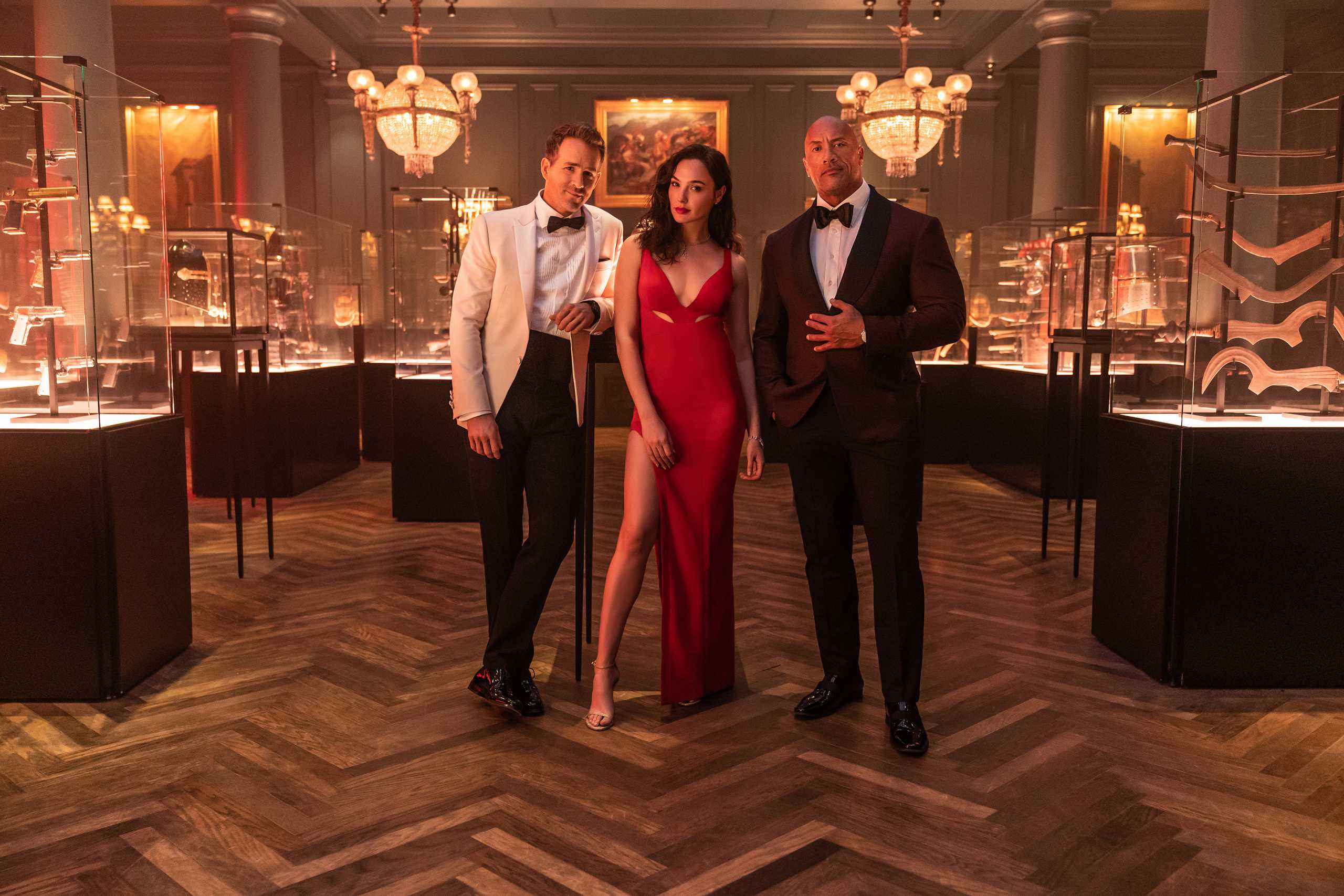 RED NOTICE - (L-R) RYAN REYNOLDS, GAL GADOT and DWAYNE ‘THE ROCK’ JOHNSON STAR IN NETFLIX’S RED NOTICE RELEASING NOVEMBER 12, 2021. WRITTEN & DIRECTED BY RAWSON MARSHALL THURBER. Cr: Frank Masi
