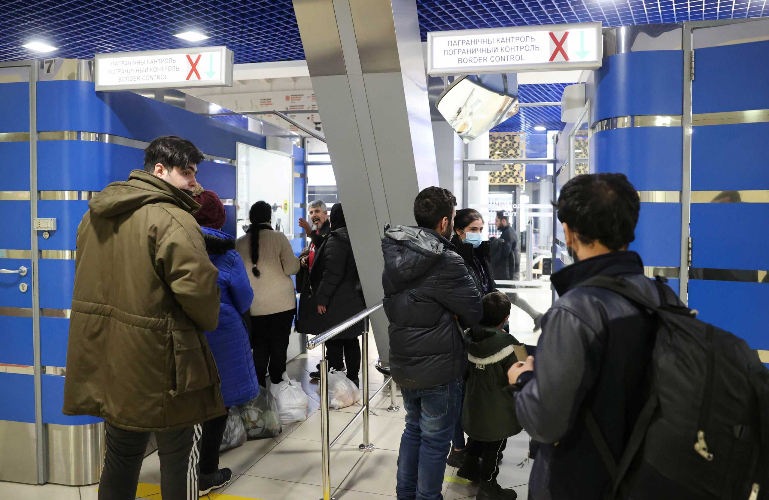 Migrants are seen at the border control area prior their departure to Iraq at the airport in Minsk, Belarus November 25, 2021. Picture taken November 25, 2021. Ramil Nasibulin