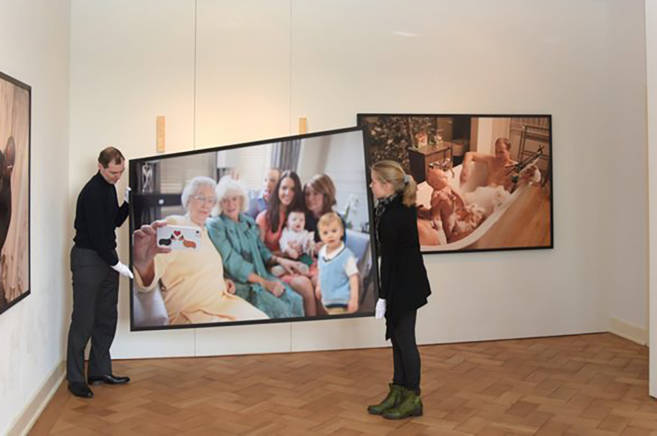 epa05214903 Museum staff hang up photographs by British artist Alison Jackson where she has composed images of people impersonating members of the British royal family, at the Museum Villa Rot in Burgrieden, Germany, 16 March 2016. The exhibition 'Me, Myself and I - Selbstdarstellung im digitalen Zeitalter' (Me, Myself and I - self-portrayal in the digital era) runs from 20 March to 19 June.  EPA