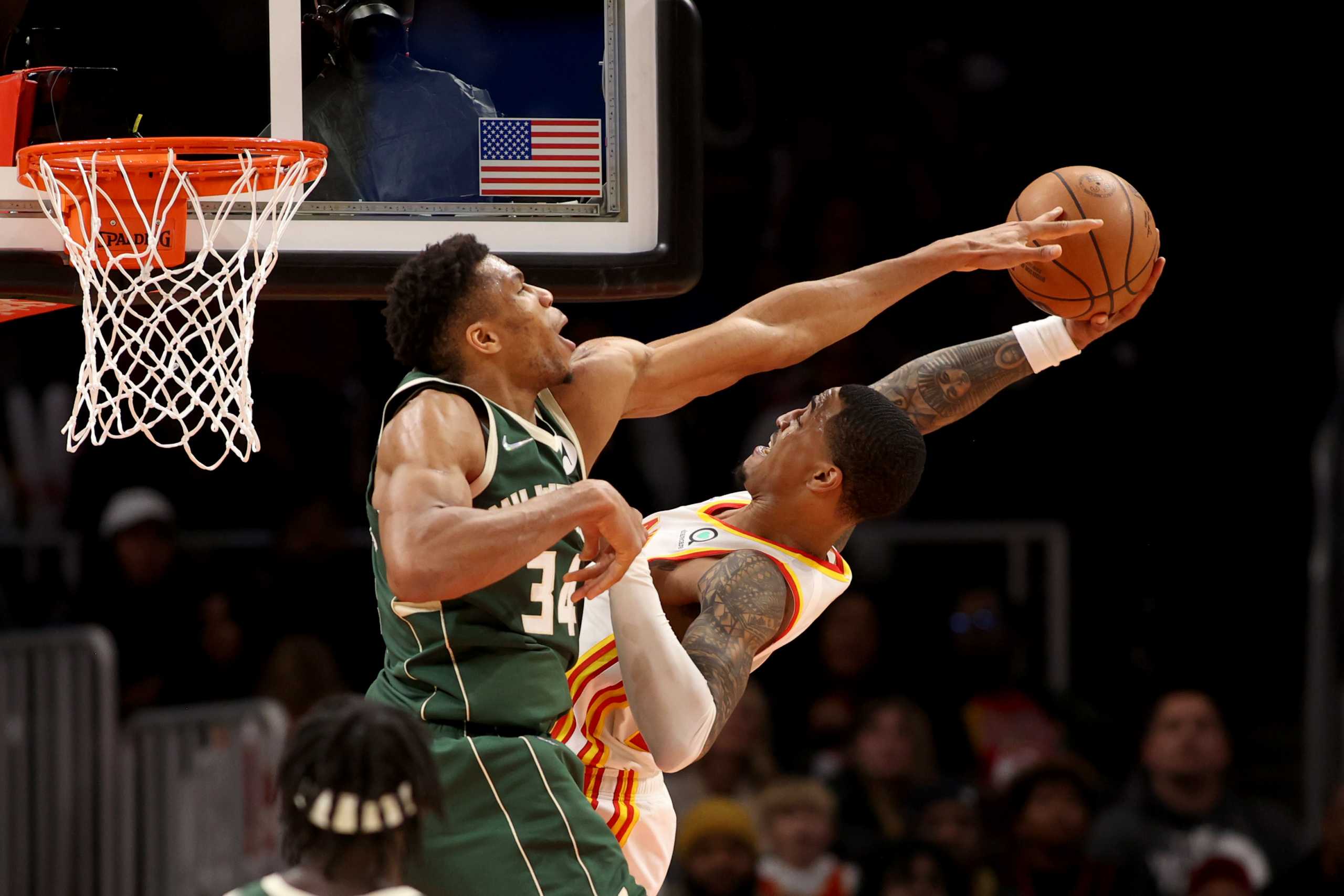 Nov 14, 2021; Atlanta, Georgia, USA; Atlanta Hawks forward John Collins (20) attempts a basket against Milwaukee Bucks forward Giannis Antetokounmpo (34) and is fouled during the second half against the Milwaukee Bucks at State Farm Arena. Mandatory Credit: Jason Getz-USA TODAY Sports