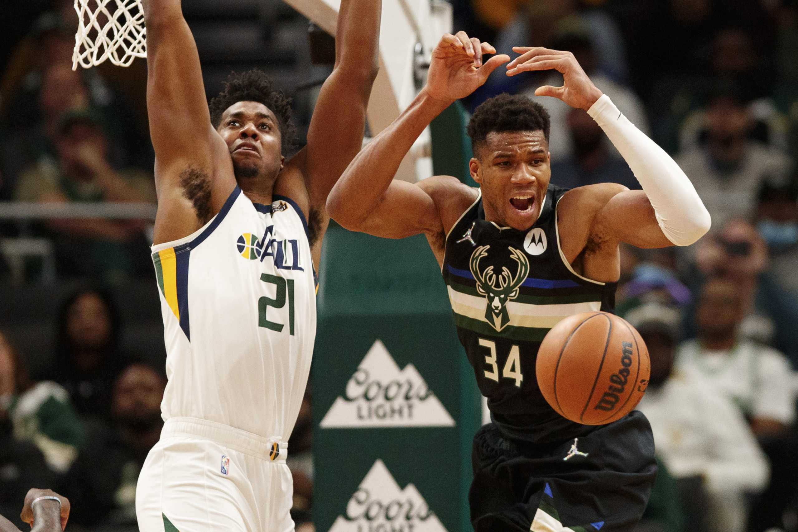 Oct 31, 2021; Milwaukee, Wisconsin, USA;  Milwaukee Bucks forward Giannis Antetokounmpo (34) loses the ball under pressure from Utah Jazz center Hassan Whiteside (21) during the fourth quarter at Fiserv Forum. Mandatory Credit: Jeff Hanisch-USA TODAY Sports