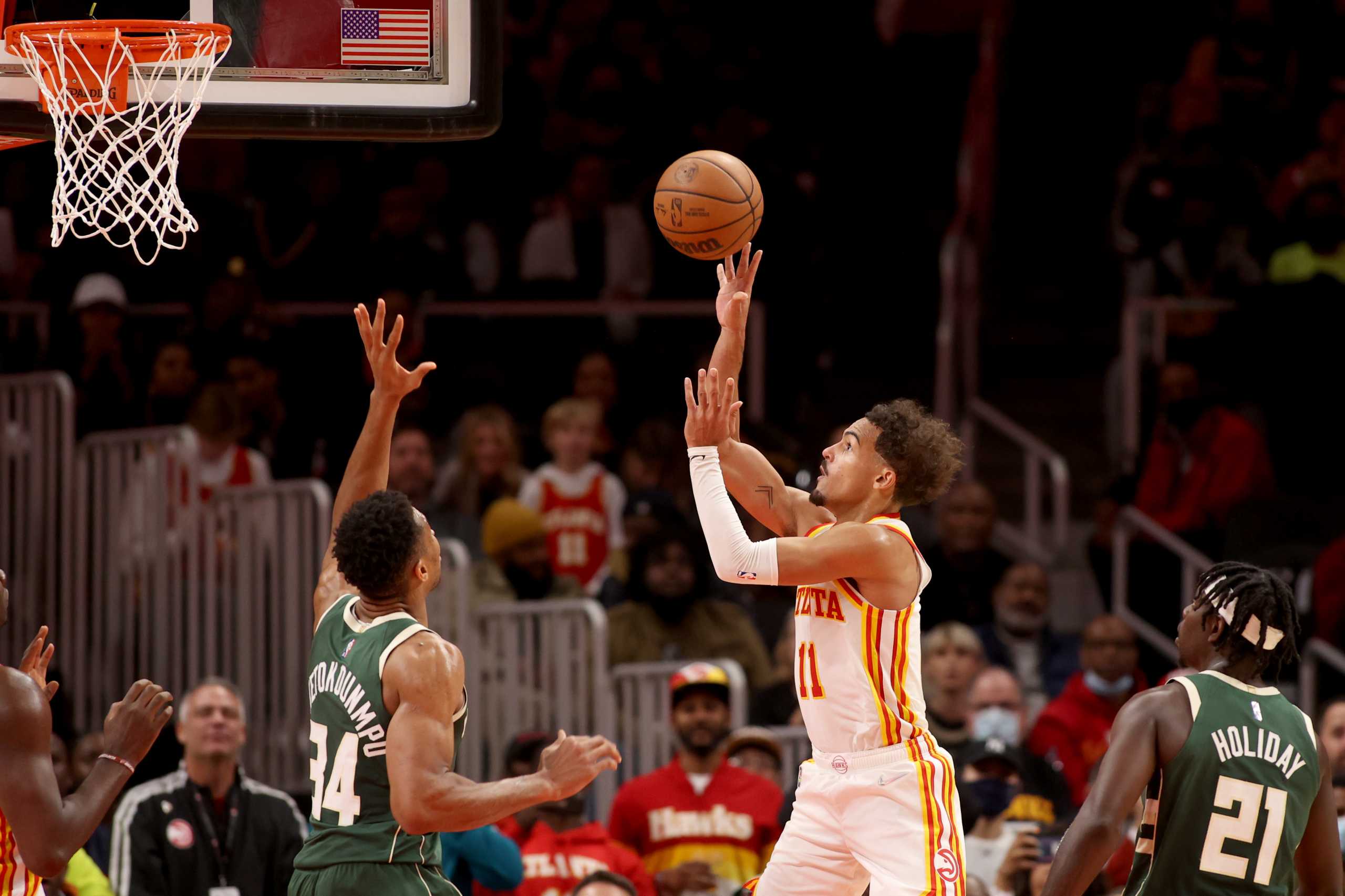 Nov 14, 2021; Atlanta, Georgia, USA; Atlanta Hawks guard Trae Young (11) attempts a shot against Milwaukee Bucks forward Giannis Antetokounmpo (34) during the second half at State Farm Arena. Mandatory Credit: Jason Getz-USA TODAY Sports