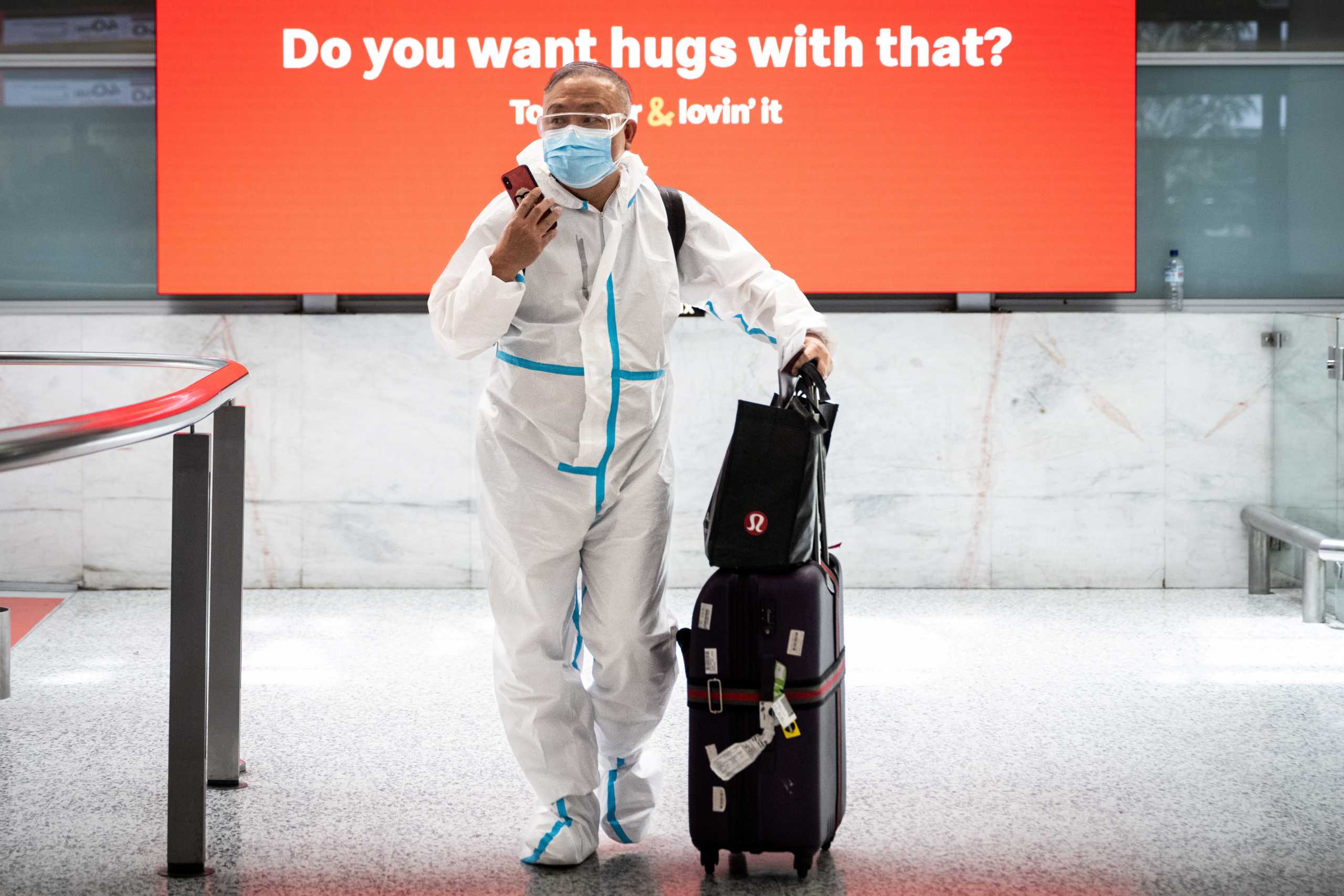 A traveller wearing personal protective equipment arrives at the international terminal at Sydney Airport, as countries react to the new Omicron variant of the coronavirus, in Sydney, Australia, November 29, 2021.  AAP Image