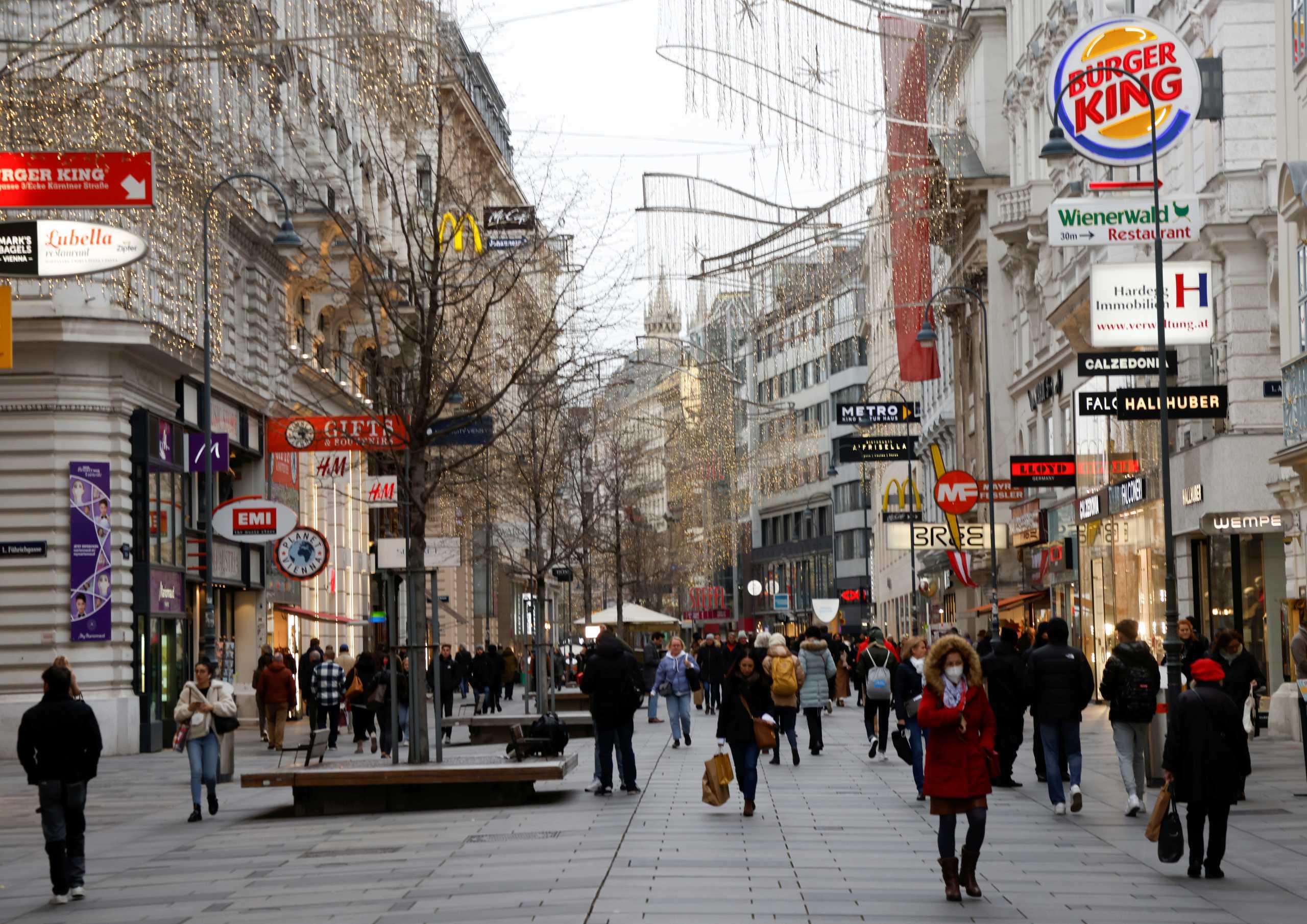 Pedestrians walk along a shopping street after the Austrian government placed roughly two million people who are not fully vaccinated against the coronavirus disease (COVID-19) on lockdown, in Vienna, Austria, November 17, 2021.   REUTERS