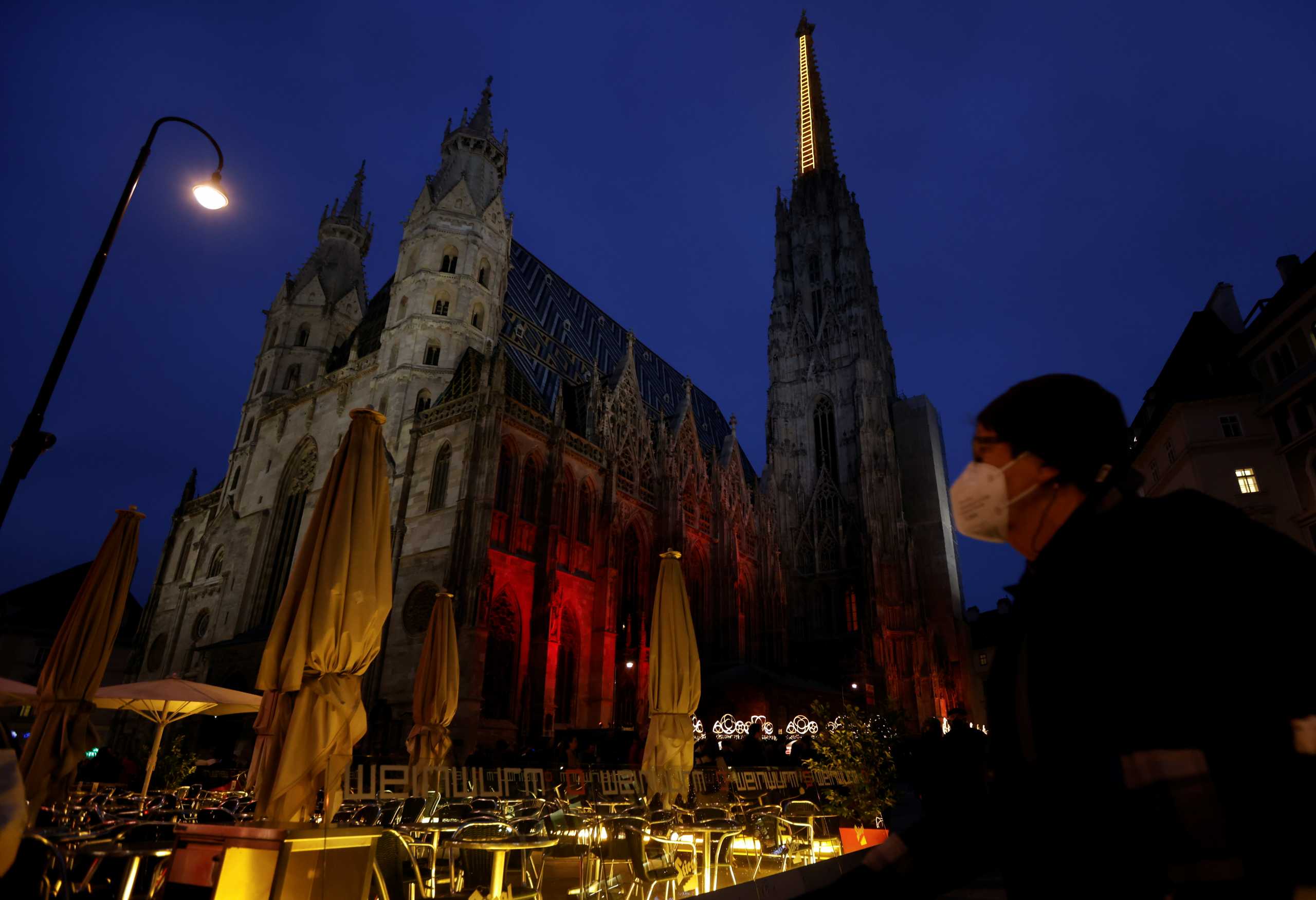 A person walks past St. Stephens cathedral amidst the coronavirus disease (COVID-19) outbreak, as Austria's government considers imposing a lockdown for people who are not fully vaccinated, in Vienna, Austria November 12, 2021.  REUTERS