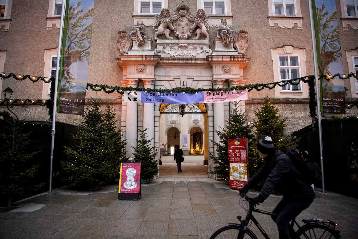 A cyclist rides in front of a closed Christmas market during the coronavirus disease (COVID-19) outbreak, as Austria's government imposed a general lockdown from Monday, in Salzburg, Austria, November 22, 2021. REUTERS