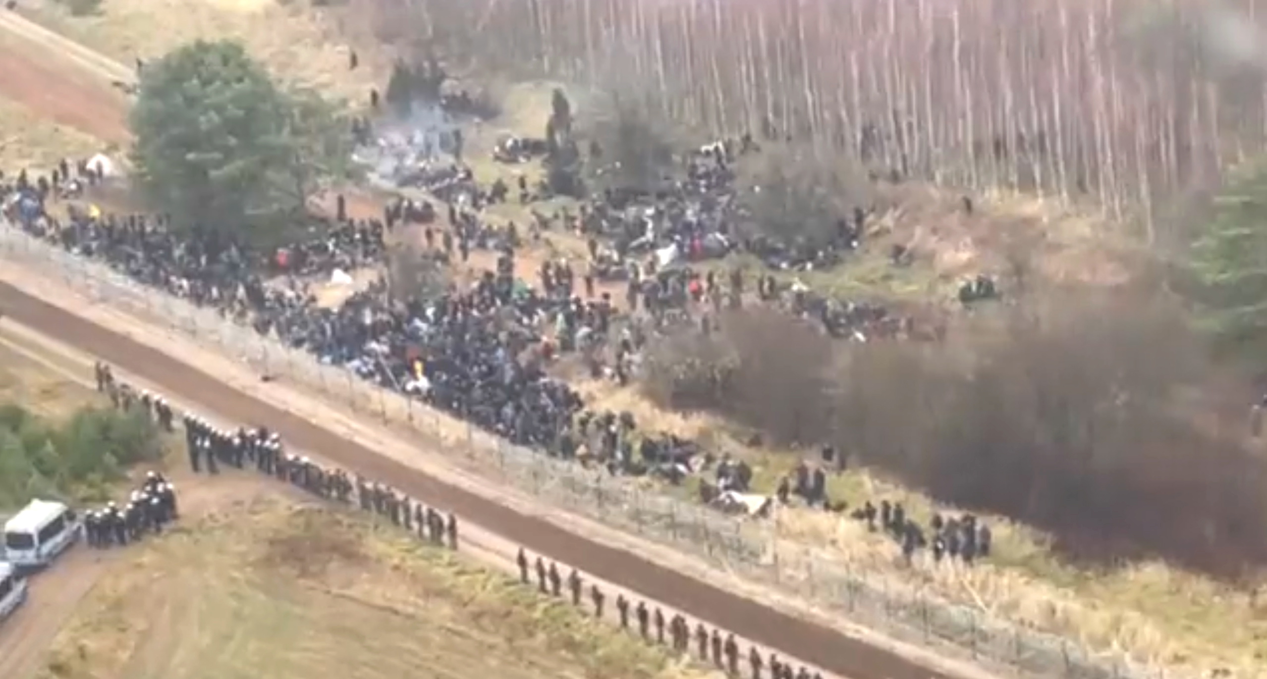 Hundreds of migrants are seen on the Belarus side of the border with Poland, guarded by the Polish soldiers near Kuznica Bialostocka, Poland, in this video-grab released by the Polish Defence Ministry, November 8, 2021. MON