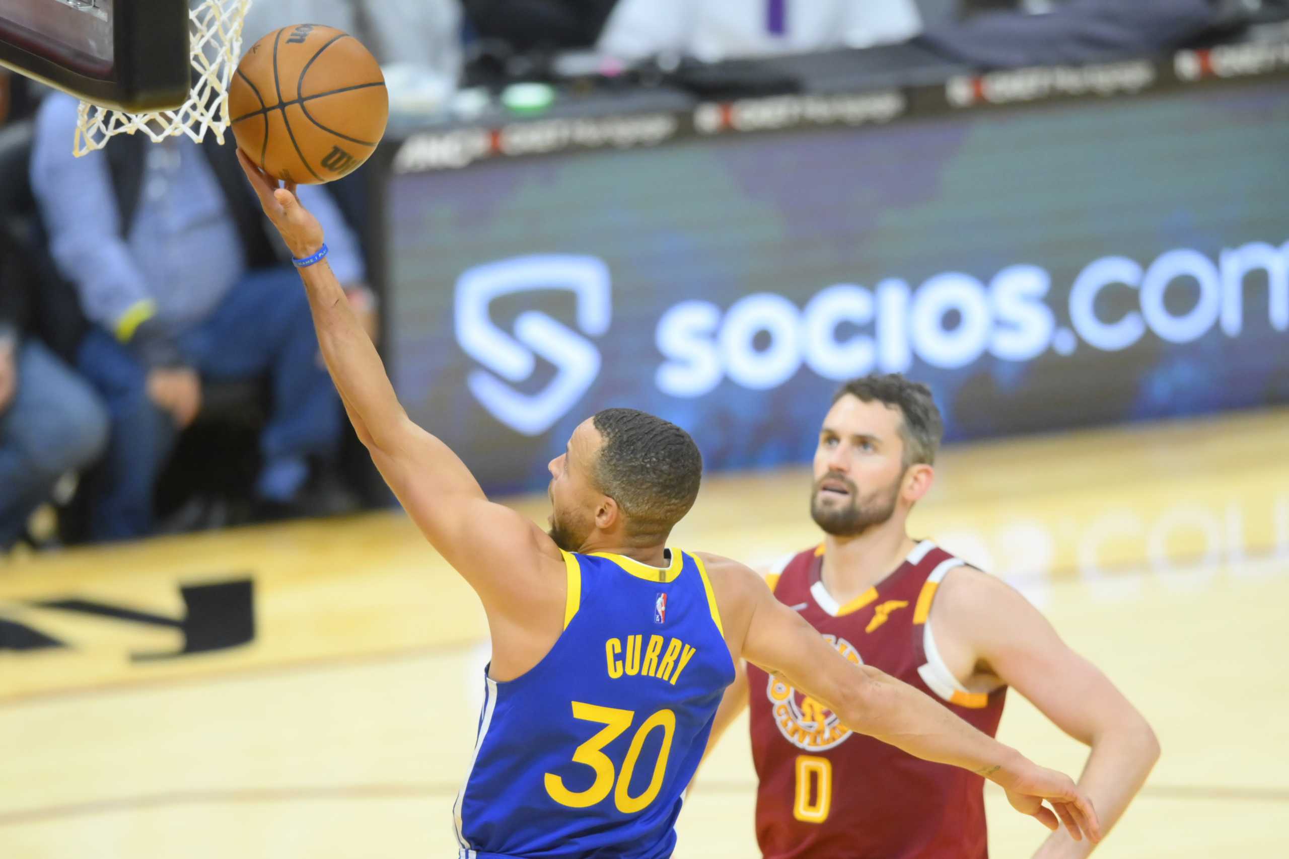 Nov 18, 2021; Cleveland, Ohio, USA; Golden State Warriors guard Stephen Curry (30) drives to the basket beside Cleveland Cavaliers forward Kevin Love (0) in the fourth quarter at Rocket Mortgage FieldHouse. Mandatory Credit: David Richard-USA TODAY Sports