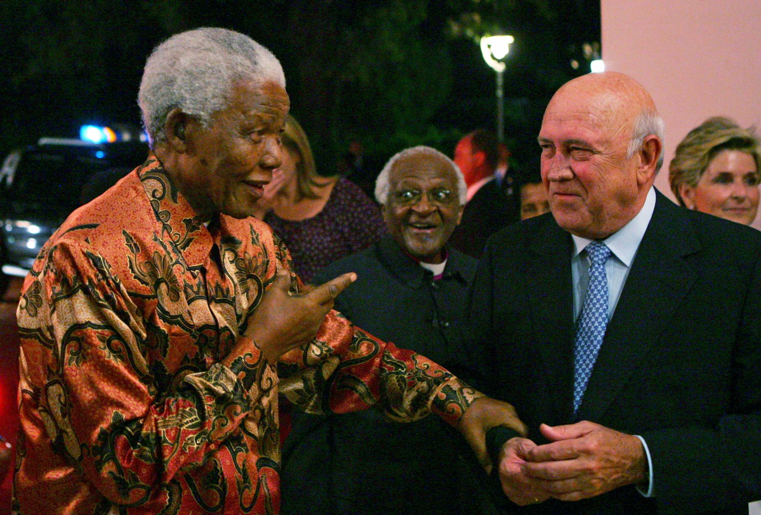FILE PHOTO: South African Nobel Peace Laureates Nelson Mandela (L) and  Archbishop Desmond Tutu (2nd L) arrive for the 70th birthday celebrations of fellow laureate former President FW de Klerk (R) in Cape Town, March 17, 2006. REUTERS
