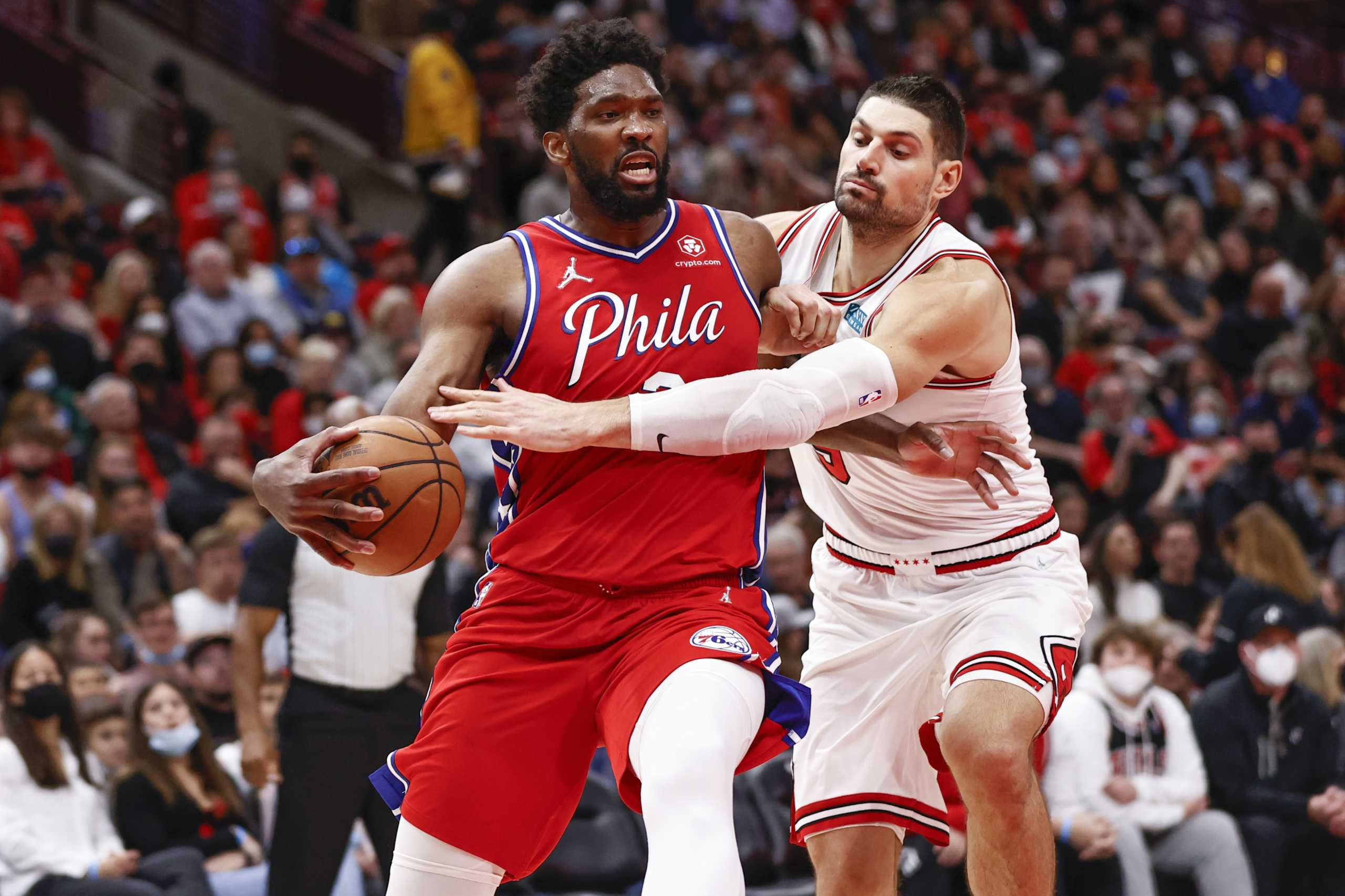 Nov 6, 2021; Chicago, Illinois, USA; Chicago Bulls center Nikola Vucevic (9) fouls Philadelphia 76ers center Joel Embiid (21) during the second half at United Center. Mandatory Credit: Kamil Krzaczynski-USA TODAY Sports