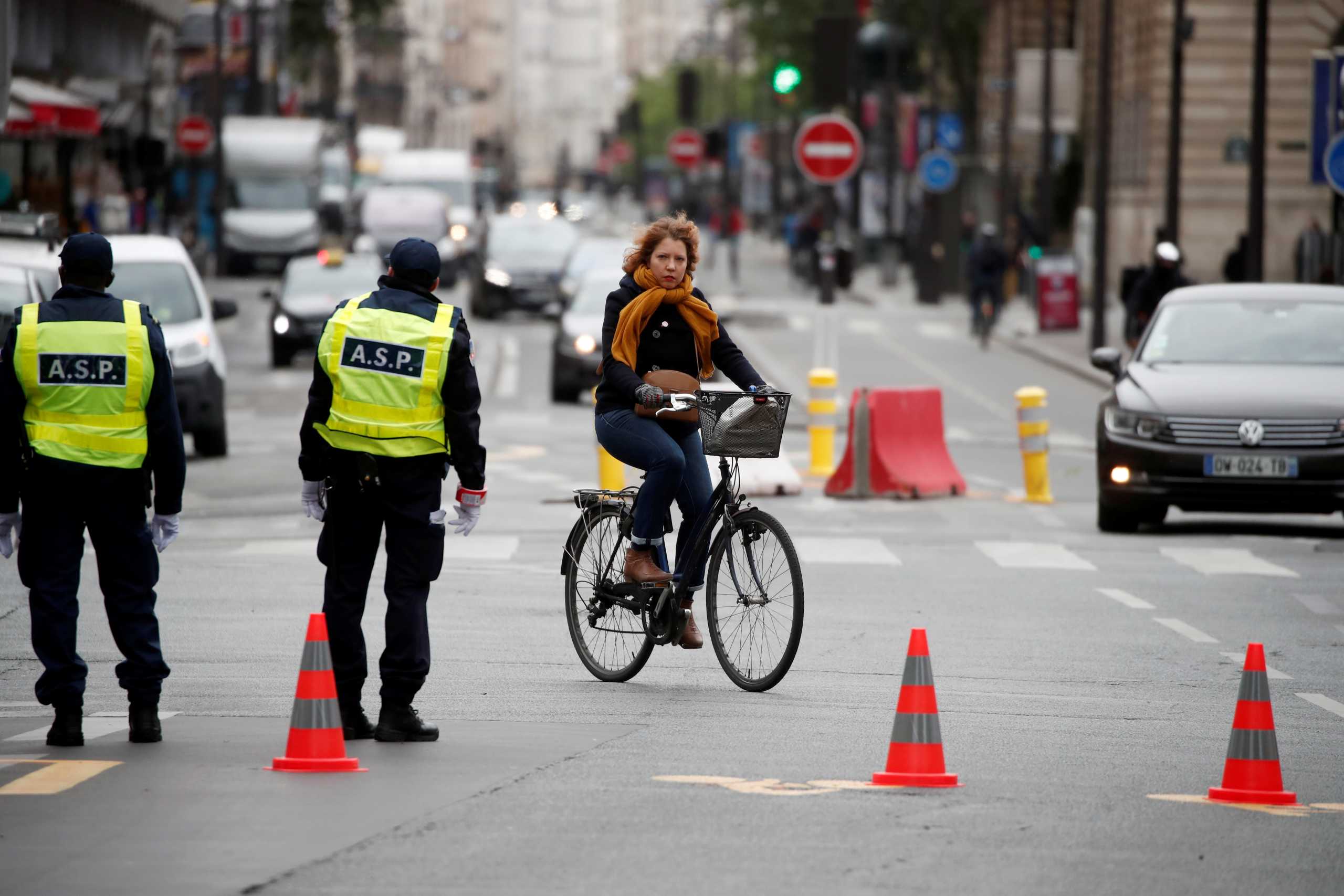 A woman rides a bicycle on a new cycling path in a street in Paris, France, on May 11, 2020.  REUTERS