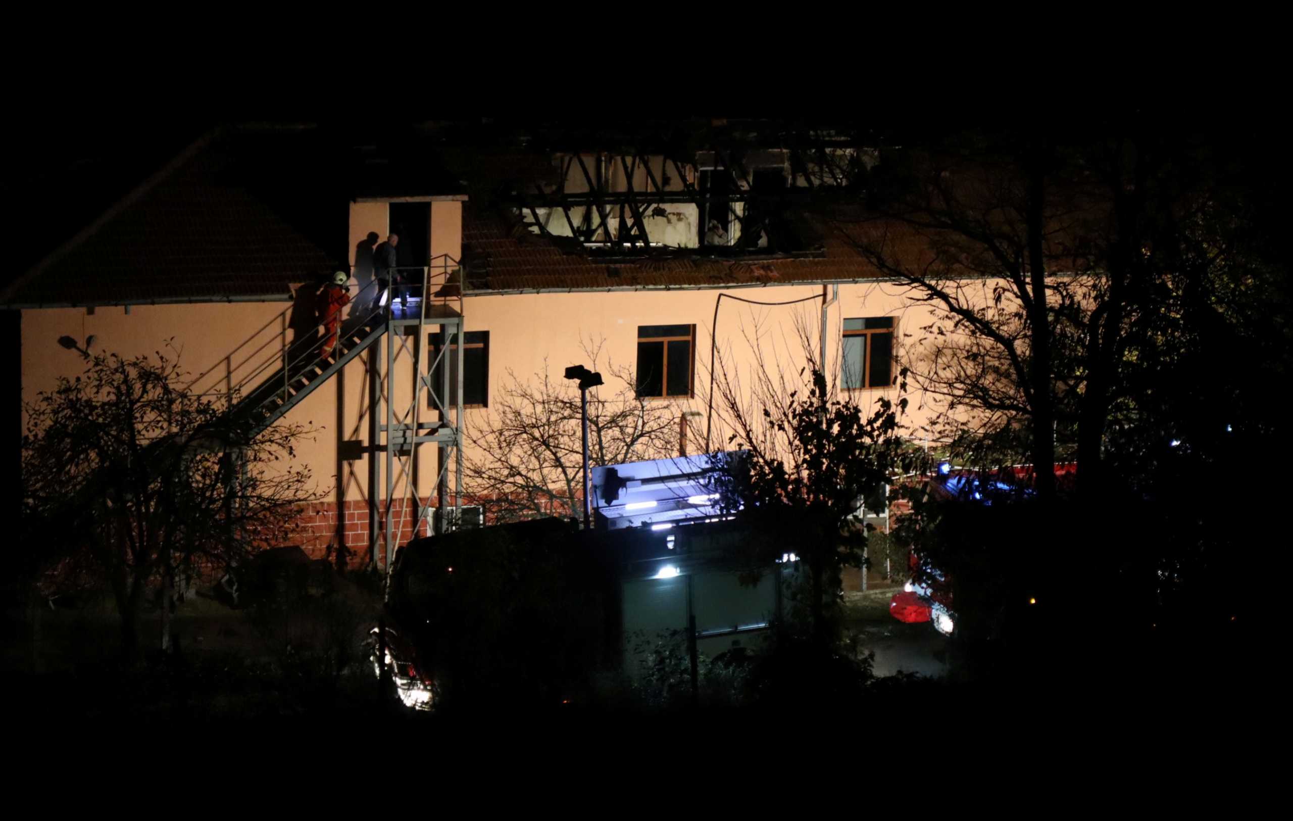 Firefighters enter a nursing home where nine people were killed in a fire in the village of Royak, Bulgaria, November 22, 2021. Lyubomir Benkovski
