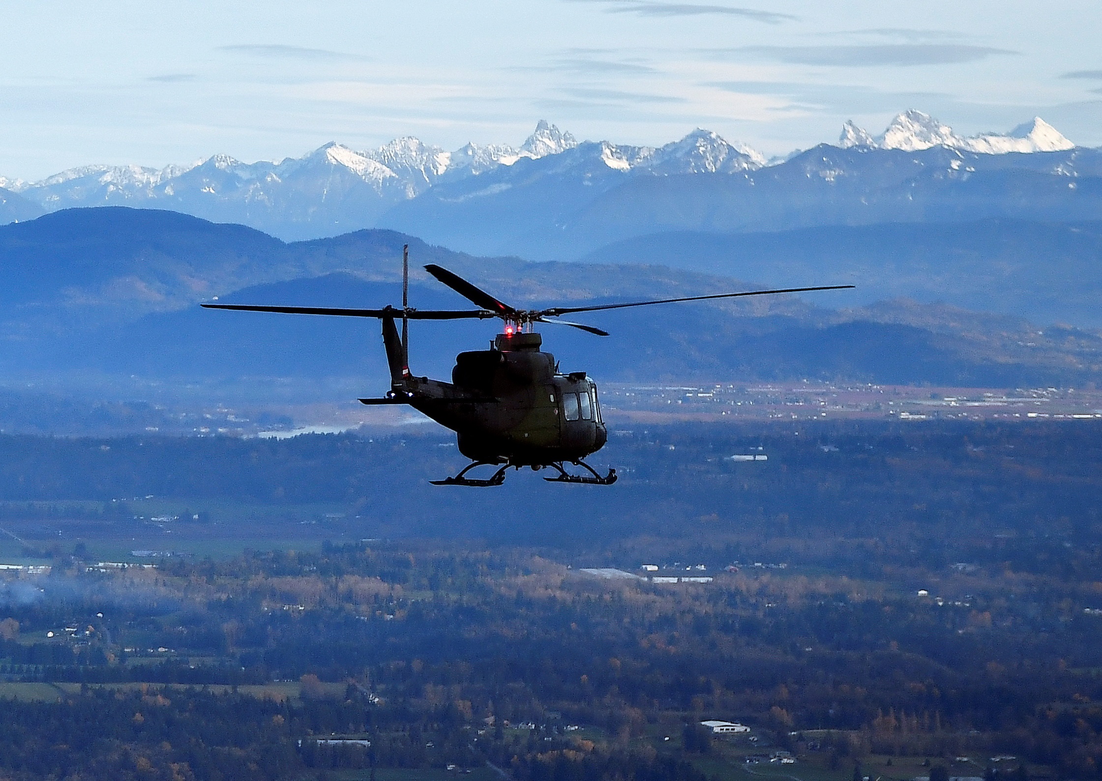 One of three Royal Canadian Air Force helicopters survey the scene after rainstorms lashed the western Canadian province of British Columbia, triggering landslides and floods, shutting highways, in Abbottsford, British Columbia, Canada November 21, 2021.  REUTERS