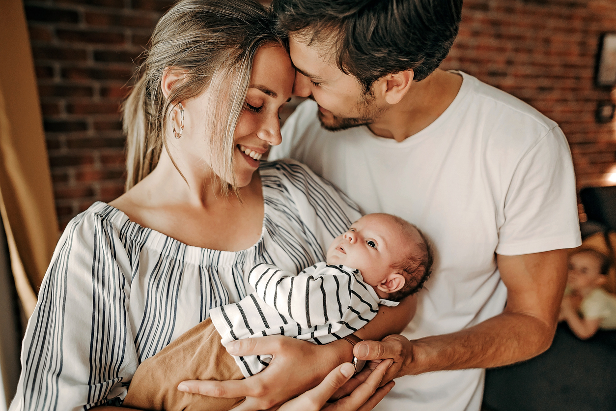 Happy family with newborn in hands