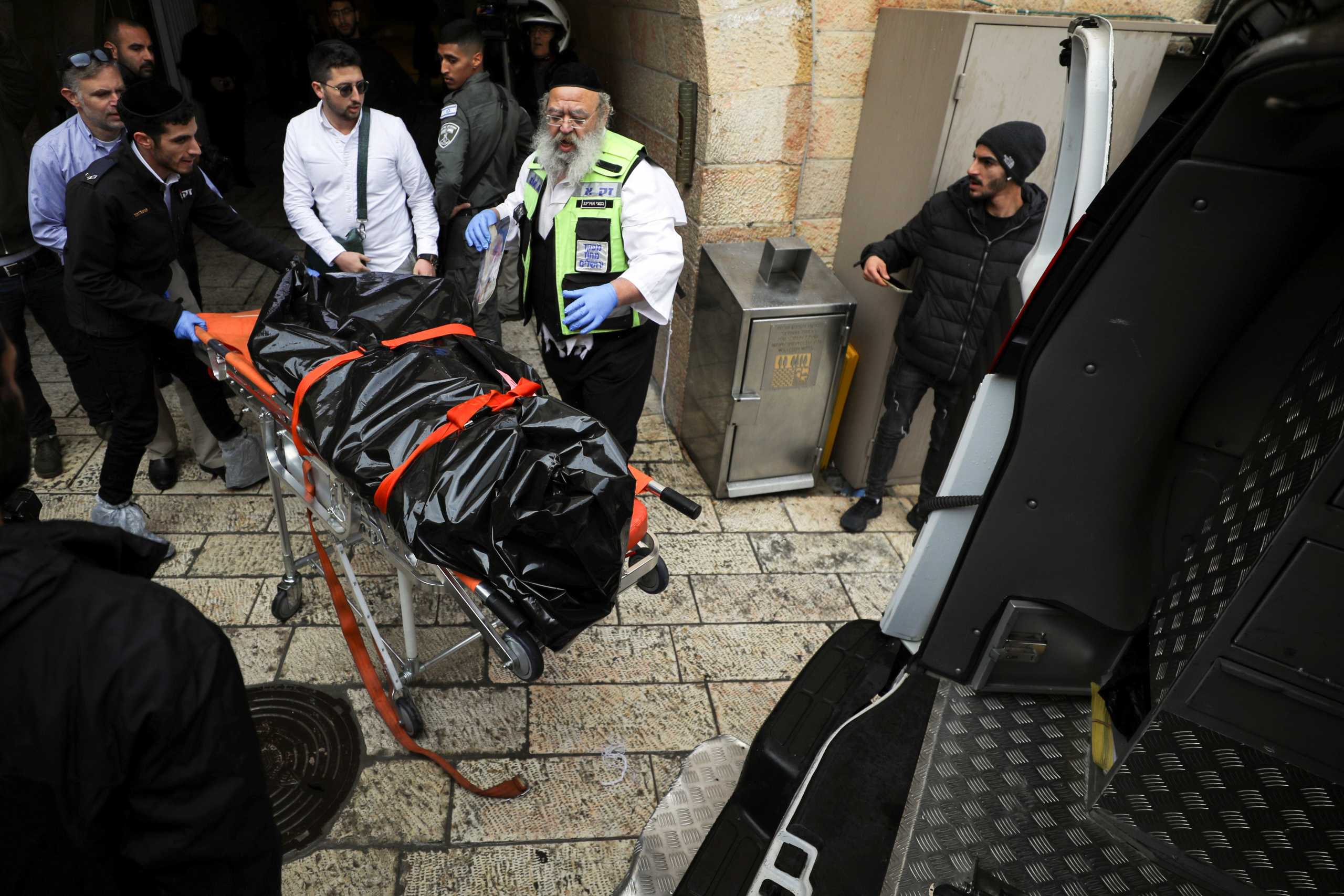 Israeli security personnel and members of Zaka Rescue and Recovery team prepare to put a dead body into an ambulance following a shooting incident in Jerusalem's Old City November 21, 2021. REUTERS