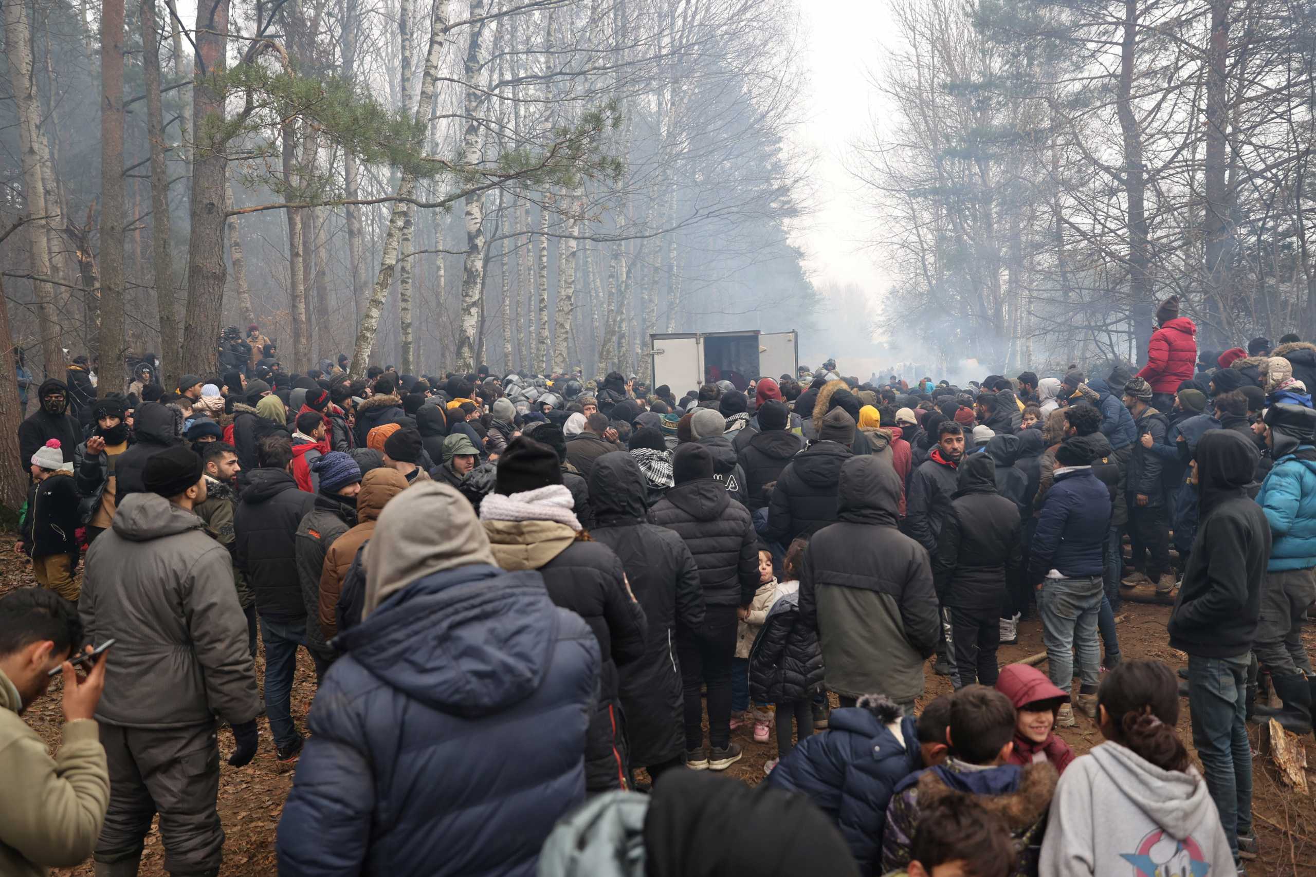 Migrants gather to receive humanitarian aid near the Belarusian-Polish border in the Grodno region, Belarus November 11, 2021. Ramil Nasibulin