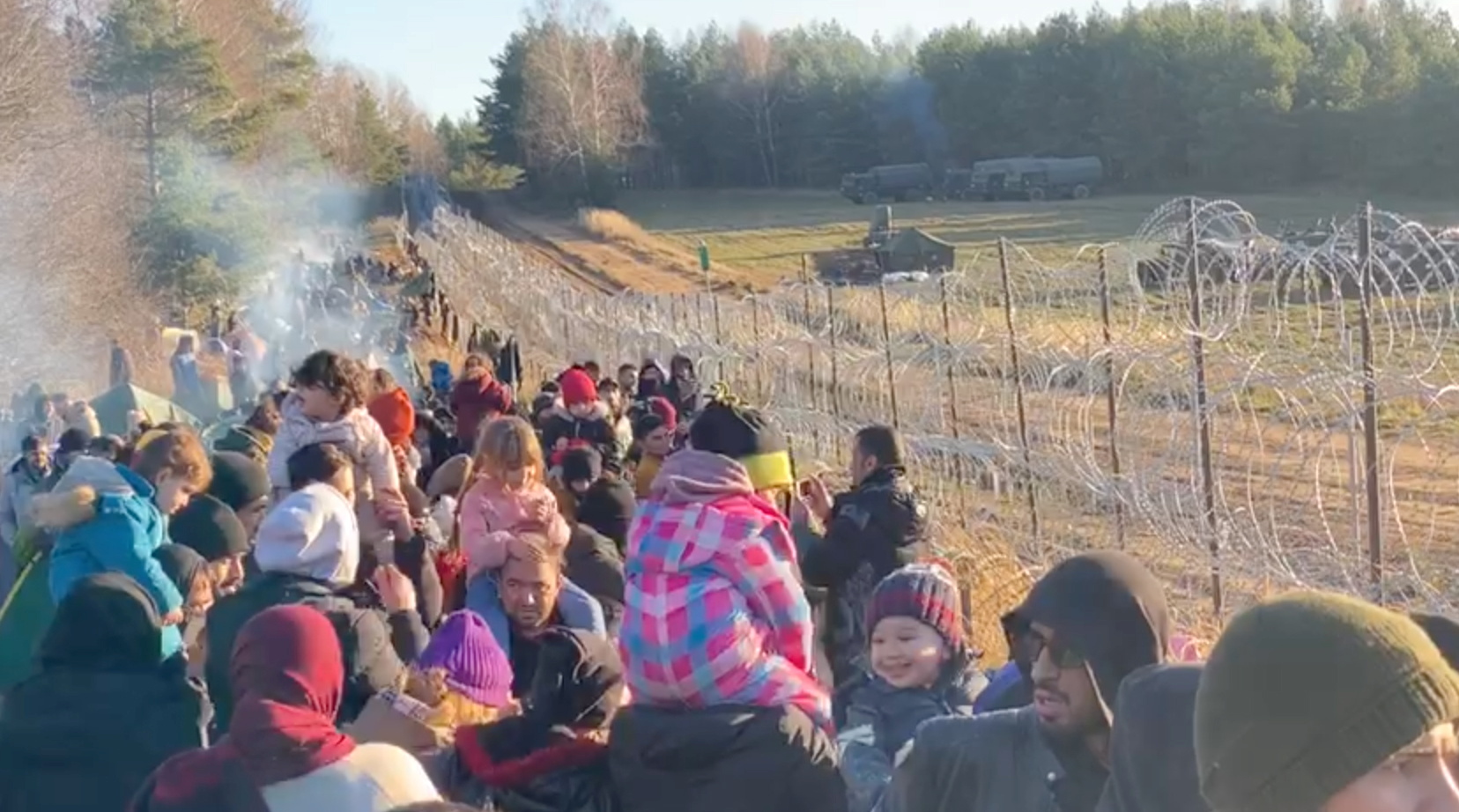 Migrants gather near a barbed wire fence on the Poland - Belarus border in Grodno District, Belarus, in this still image taken from a social media video on November 9, 2021. Obtained by REUTERS THIS IMAGE HAS BEEN SUPPLIED BY A THIRD PARTY. MANDATORY CREDIT. NO RESALES. NO ARCHIVES.