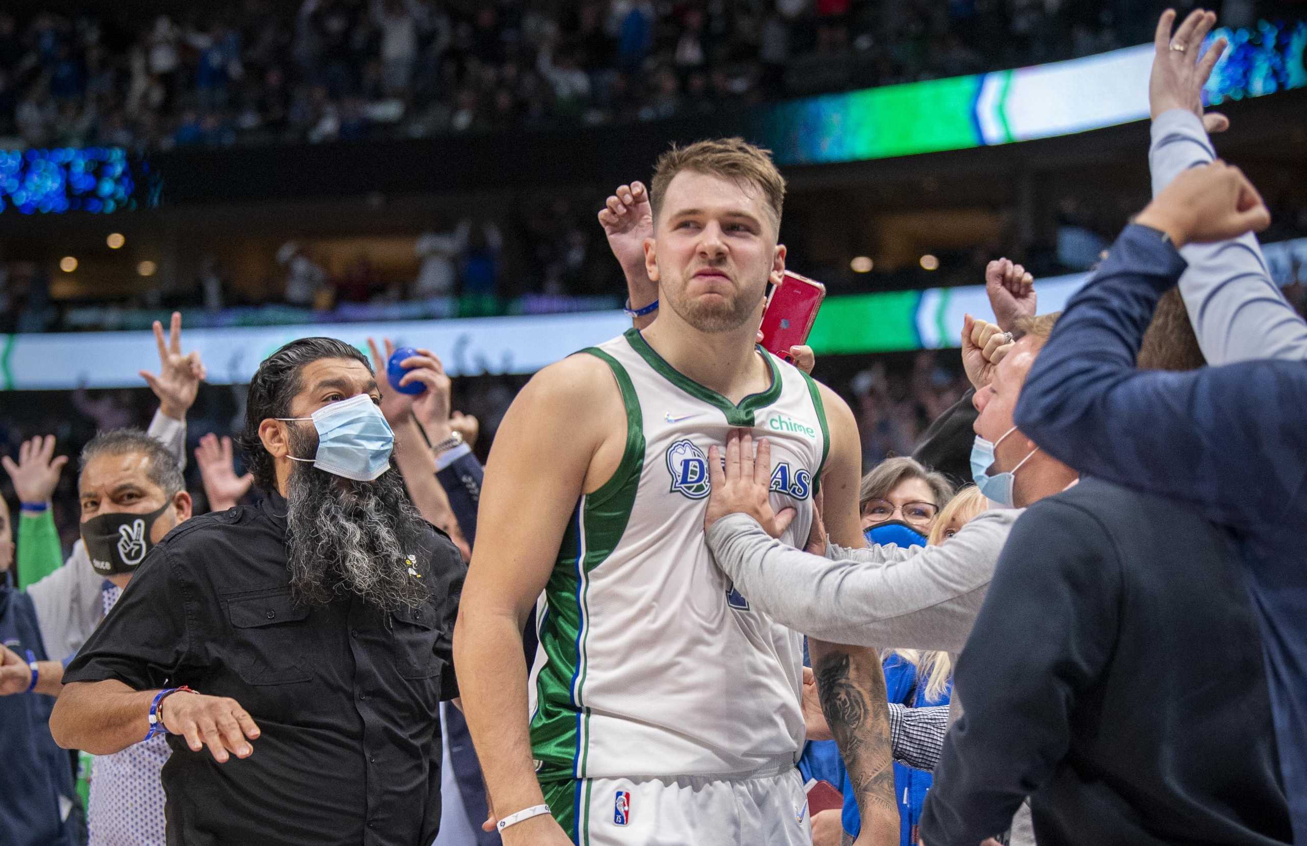 Nov 6, 2021; Dallas, Texas, USA; Dallas Mavericks guard Luka Doncic (77) and the Maverick fans celebrate Doncic making the game winning shot as time expires during the fourth quarter against the Boston Celtics at the American Airlines Center. Mandatory Credit: Jerome Miron-USA TODAY Sports