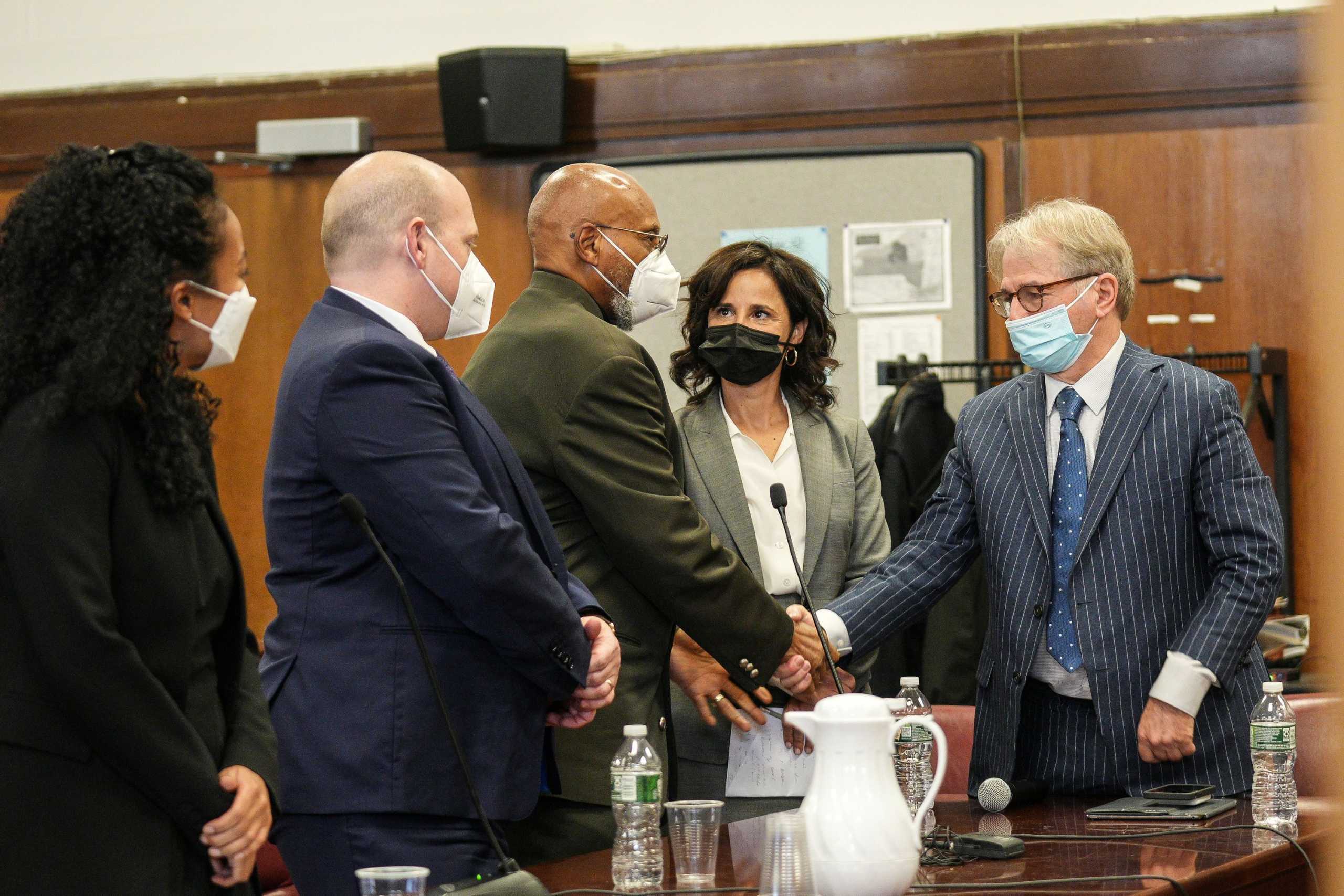 Muhammad Aziz, 83, one of the two men who spent decades in prison for murdering Black activist and civil rights advocate Malcolm X in 1965, shakes hands with lawyers during his exoneration trial by a New York state judge at State Supreme Court in New York City, U.S., November 18, 2021.   Curtis Means