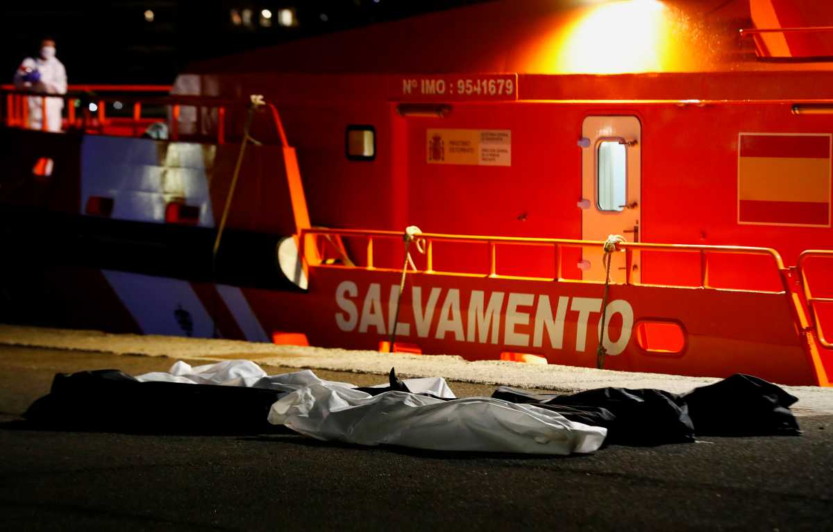 The bodies of seven deceased migrants are seen in the port of Arguineguin after being disembarked from from a Spanish coast guard vessel, in the island of Gran Canaria, Spain, November 14, 2021. REUTERS