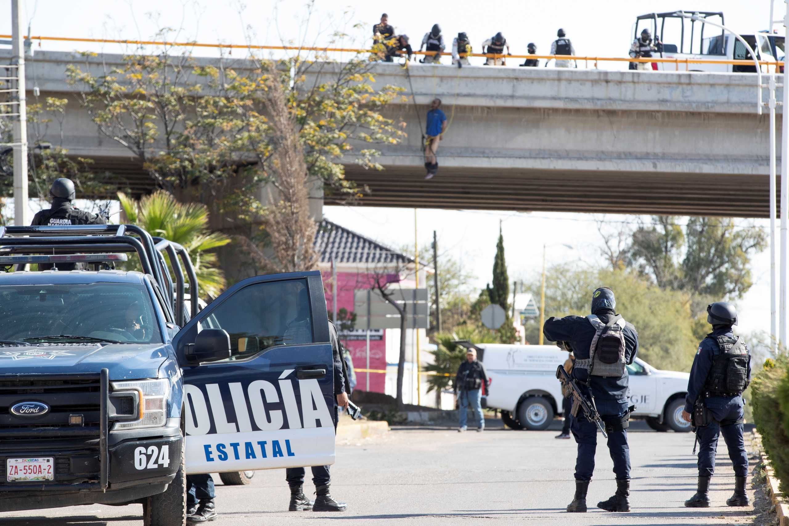 SENSITIVE MATERIAL. THIS IMAGE MAY OFFEND OR DISTURB  Members of the National Guard work at a crime scene where assailants left 10 bodies of men hanging from a bridge, in Ciudad Cuauhtemoc, in Zacatecas state, Mexico November 18, 2021. REUTERS