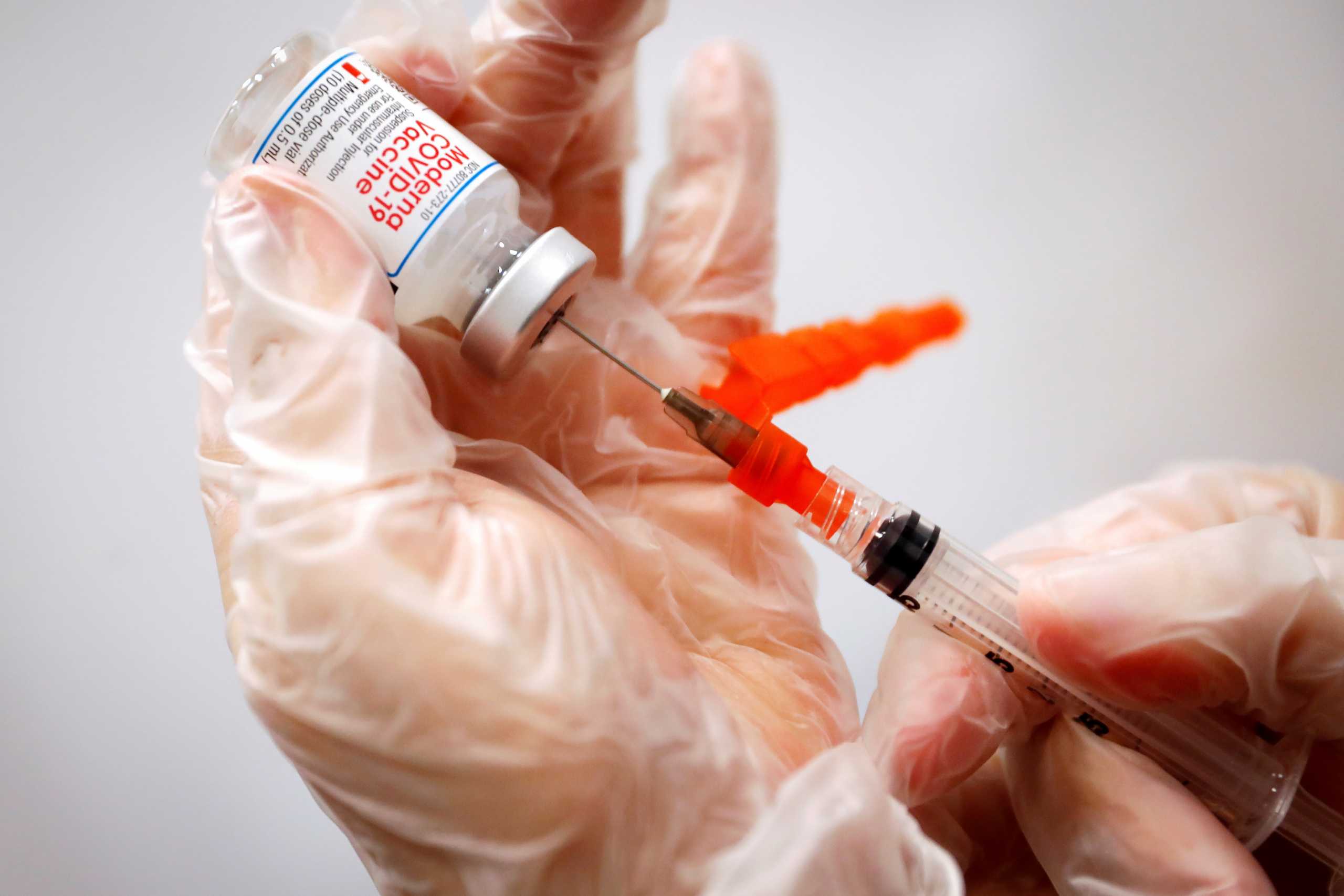 FILE PHOTO: A healthcare worker prepares a syringe with the Moderna COVID-19 Vaccine at a pop-up vaccination site operated by SOMOS Community Care during the COVID-19 pandemic in Manhattan in New York City, New York, U.S., January 29, 2021. REUTERS