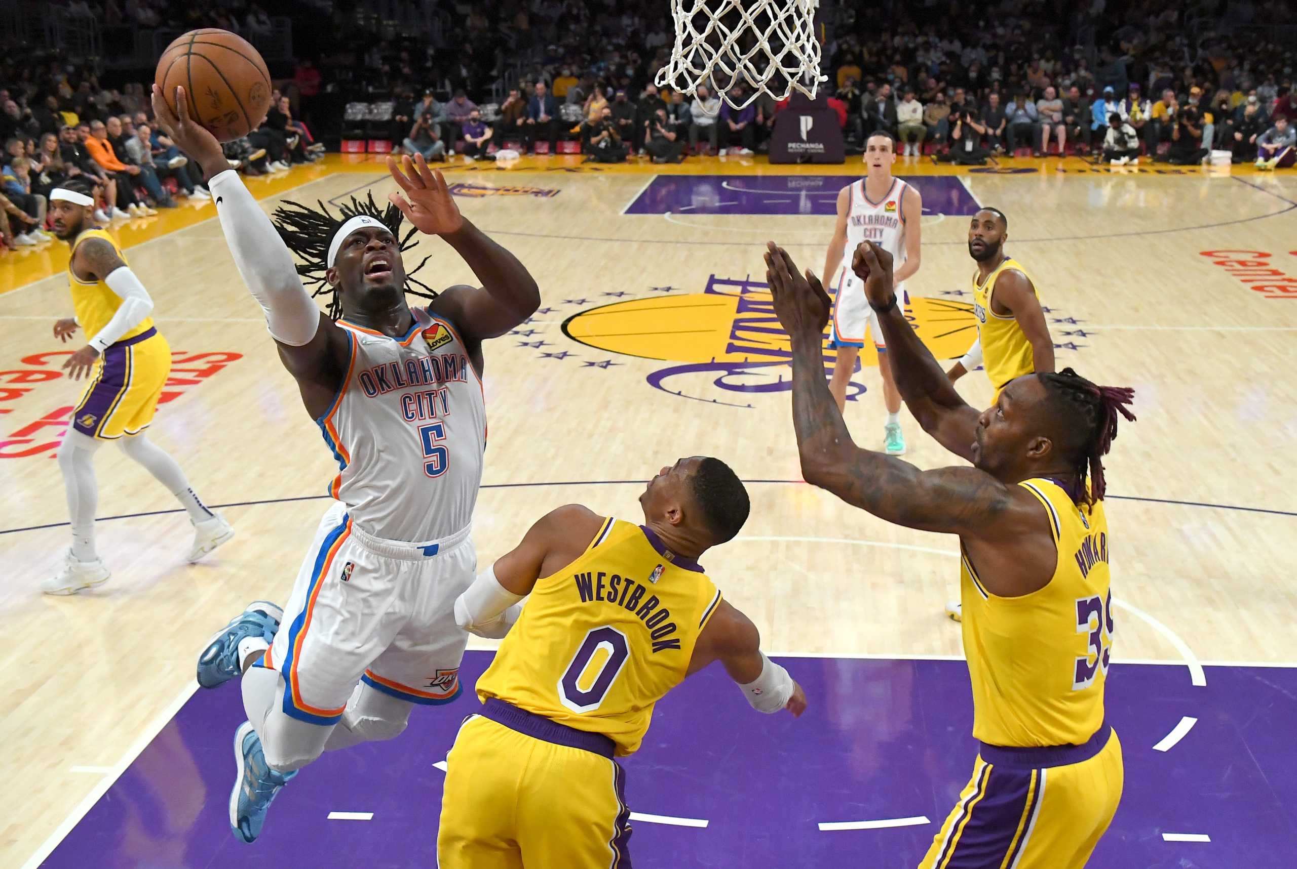 Nov 4, 2021; Los Angeles, California, USA; Oklahoma City Thunder forward Luguentz Dort (5) drives to the basket over Los Angeles Lakers guard Russell Westbrook (0) and center Dwight Howard (39) in the first half at Staples Center. Mandatory Credit: Jayne Kamin-Oncea-USA TODAY Sports
