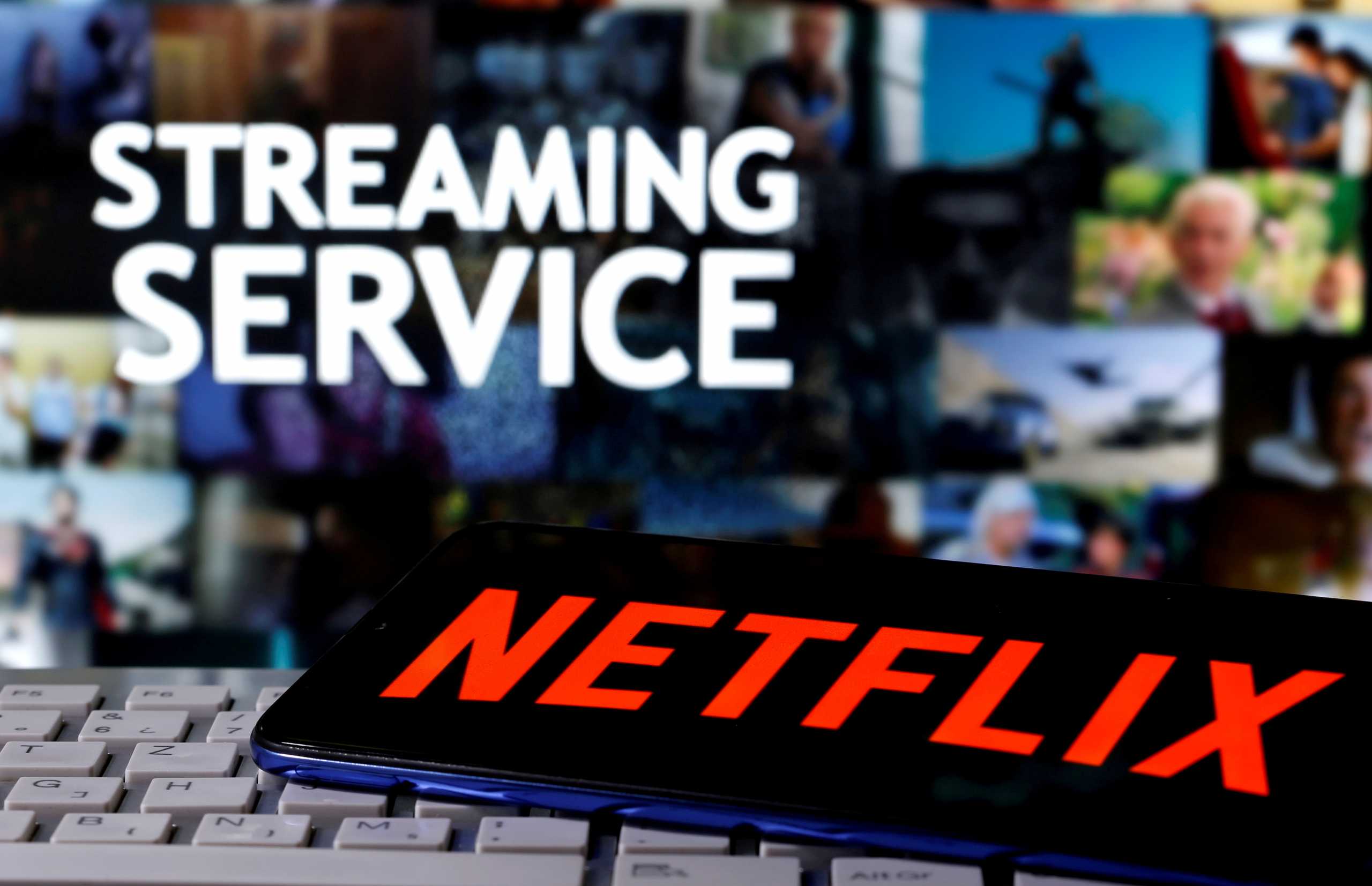 FILE PHOTO: A smartphone with the Netflix logo is seen on a keyboard in front of displayed "Streaming service" words in this illustration taken March 24, 2020. REUTERS