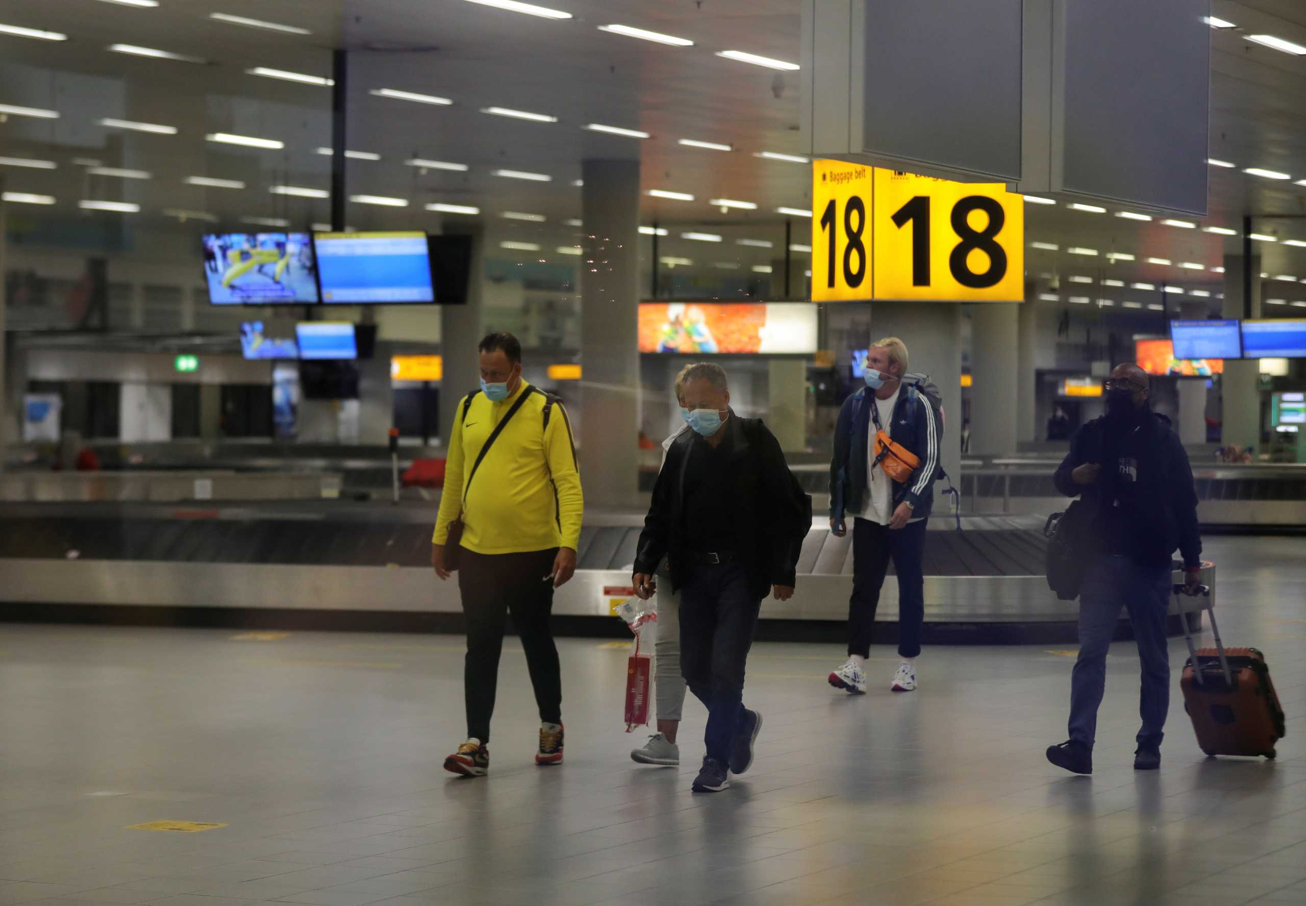 People walk inside Schiphol Airport after Dutch health authorities said that 61 people who arrived in Amsterdam on flights from South Africa tested positive for COVID-19, in Amsterdam, Netherlands, November 27, 2021. REUTERS