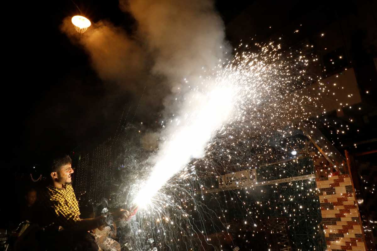A man lights a firework during Diwali, the Hindu festival of lights, in Karachi, Pakistan November 4, 2021. REUTERS