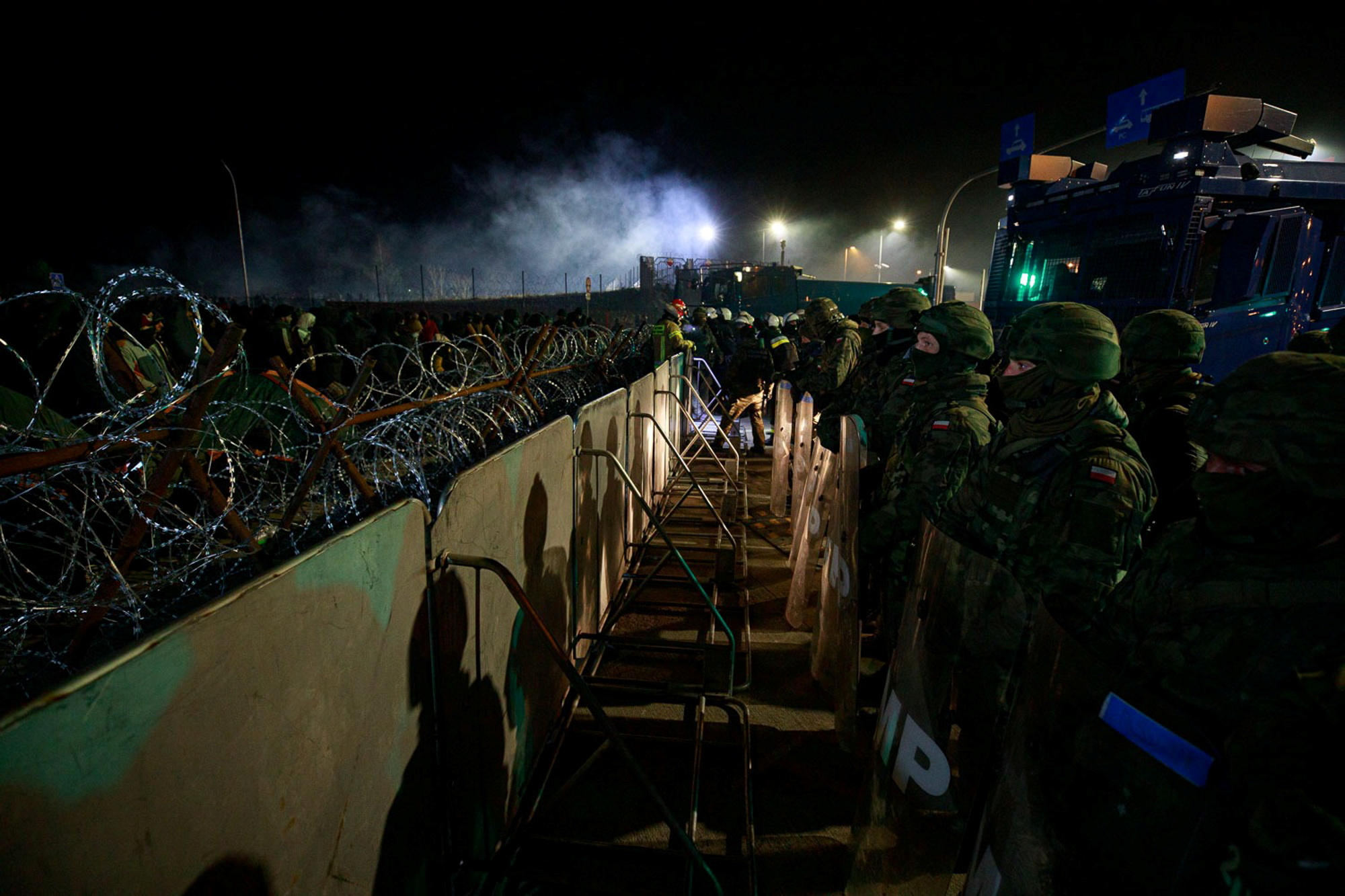 Polish Territorial Defence Forces and police secure additional fence where hundreds of migrants camp at the Belarus side of Kuznica Bialostocka-Bruzgi border crossing, Poland in this photograph released by the Territorial Defence Forces, November 15, 2021. Territorial Defence Forces