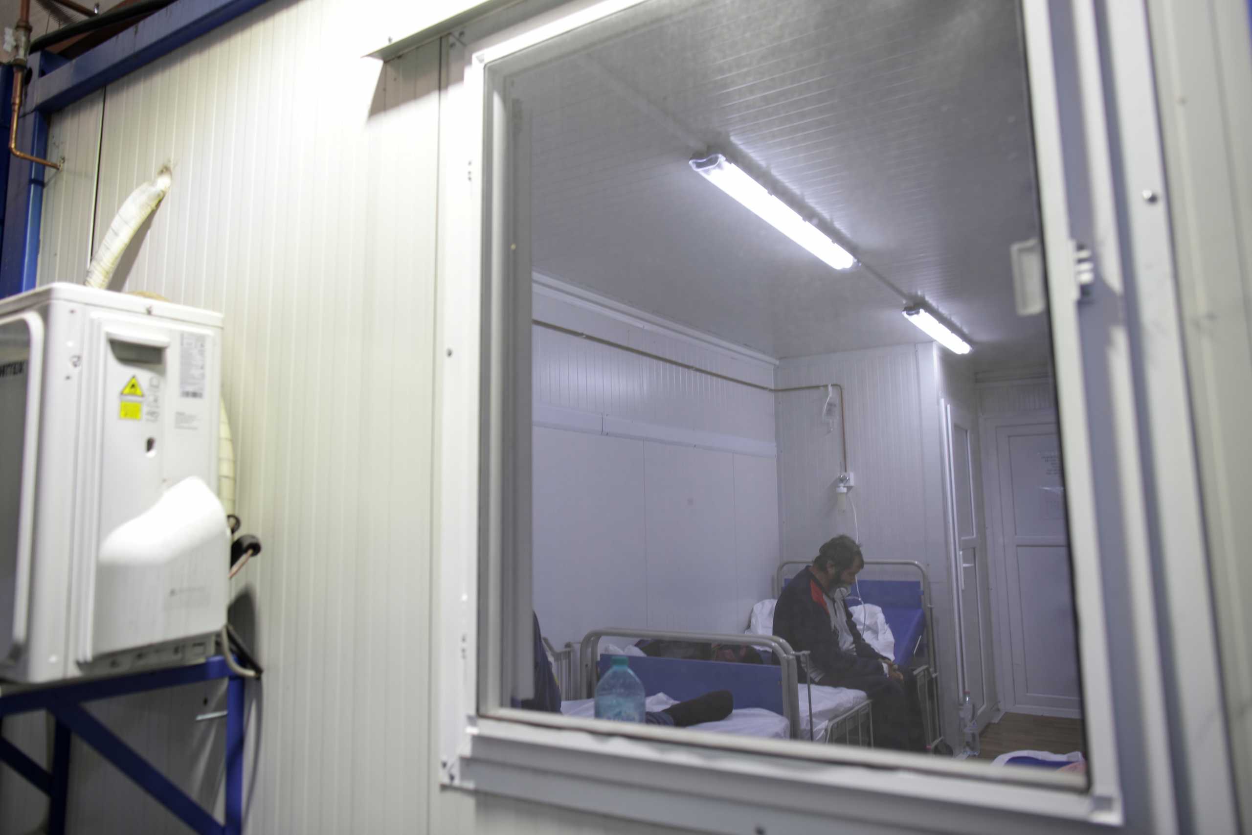 A patient sits on the side of a bed while receiving oxygen through a mask in the COVID-19 ER unit at Giurgiu County Emergency Hospital, in Giurgiu, Romania November 4, 2021. Inquam Photos