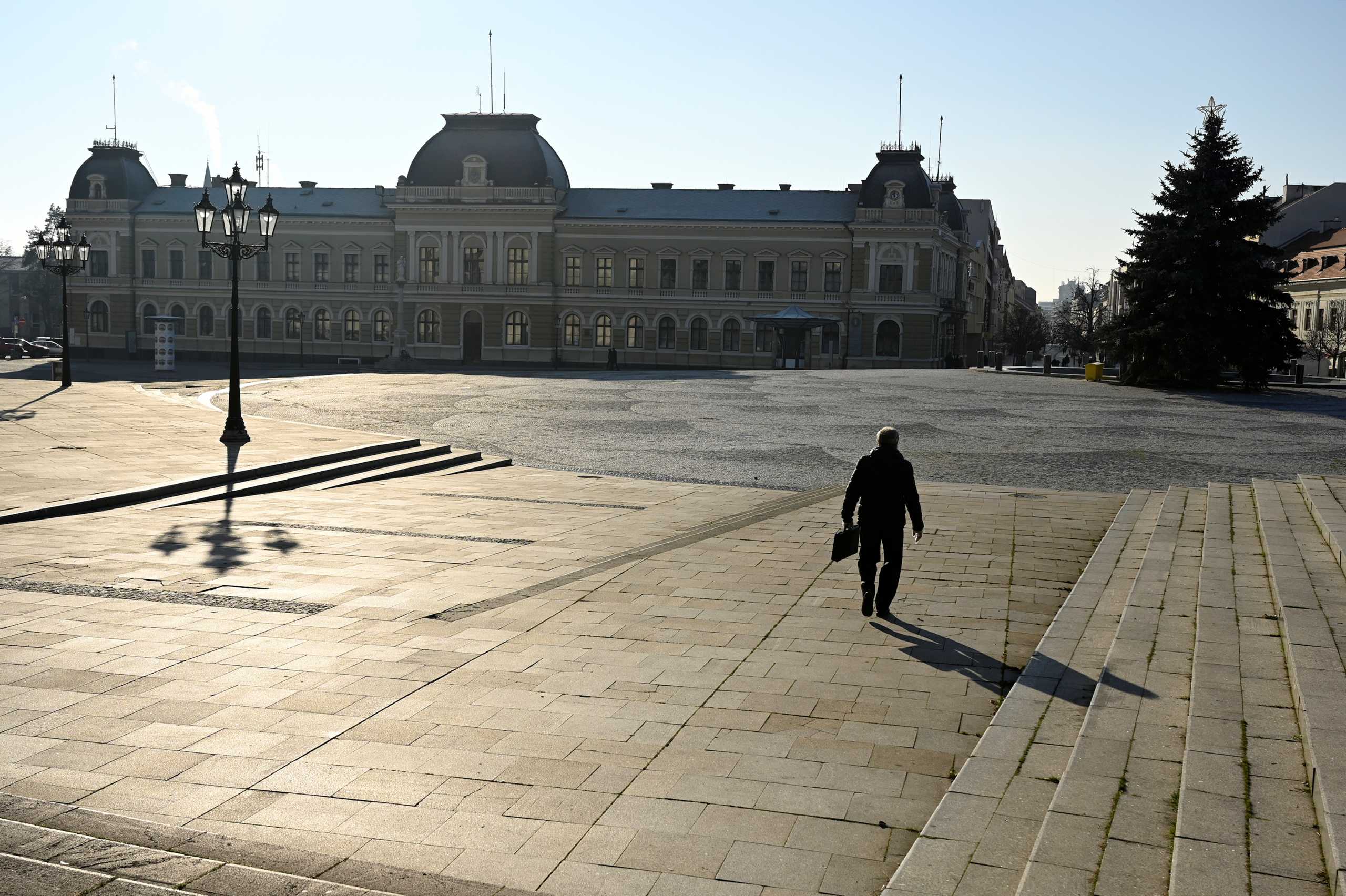 FILE PHOTO: A man walks through the empty downtown, amid the spread of the coronavirus disease (COVID-19),  in Nitra, Slovakia January 11, 2021. REUTERS