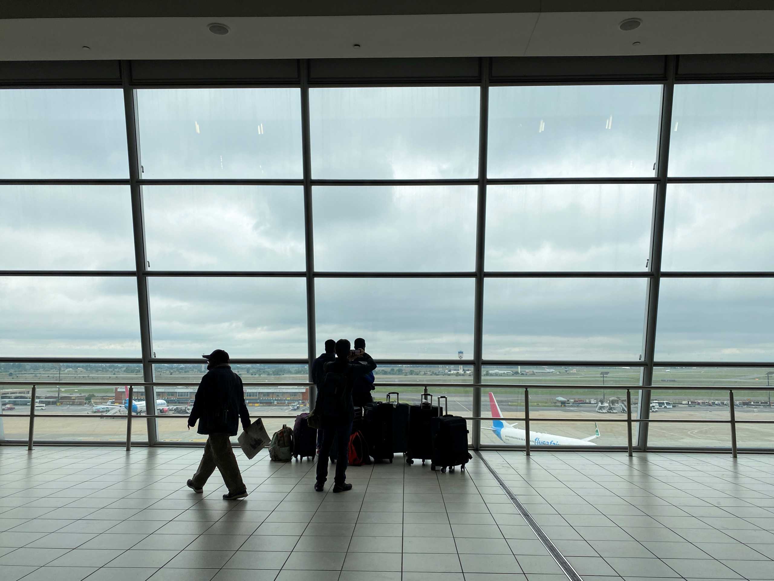 Passengers wait to board flights, amidst the spread of the new SARS-CoV-2 variant, at O.R. Tambo International Airport in Johannesburg, South Africa, November 27, 2021. REUTERS