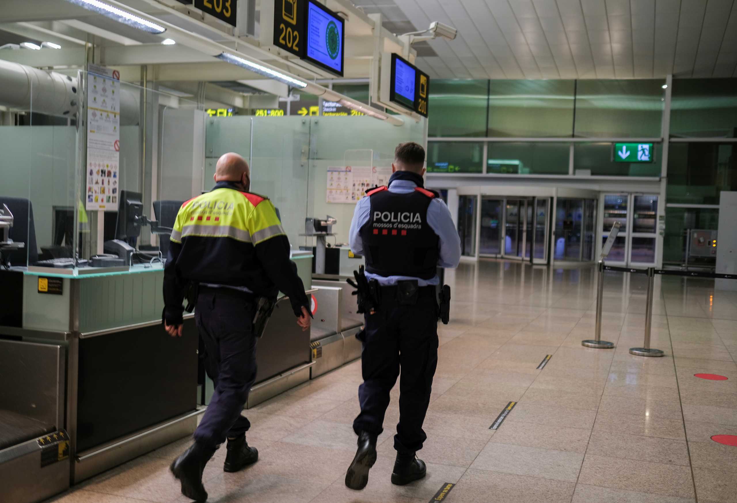 Police officers patrol at Josep Tarradellas Barcelona-El Prat Airport, in Barcelona, Spain, November 19, 2021. REUTERS