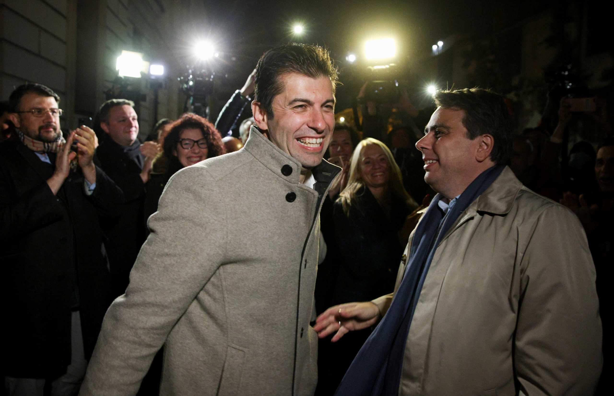 Kiril Petkov and Assen Vassilev, leaders of Bulgaria's new centrist party "We Continue the Change", react after the first exit polls during parliamentary and presidential elections, in Sofia, Bulgaria, November 14, 2021. REUTERS