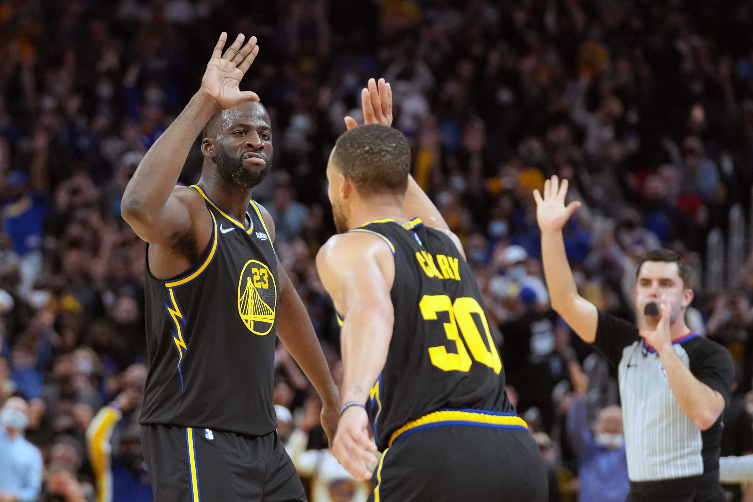 Nov 26, 2021; San Francisco, California, USA; Golden State Warriors guard Stephen Curry (30) is congratulated by forward Draymond Green (23) after hitting a 3-pointer against the Portland Trail Blazers at Chase Center. Mandatory Credit: Darren Yamashita-USA TODAY Sports