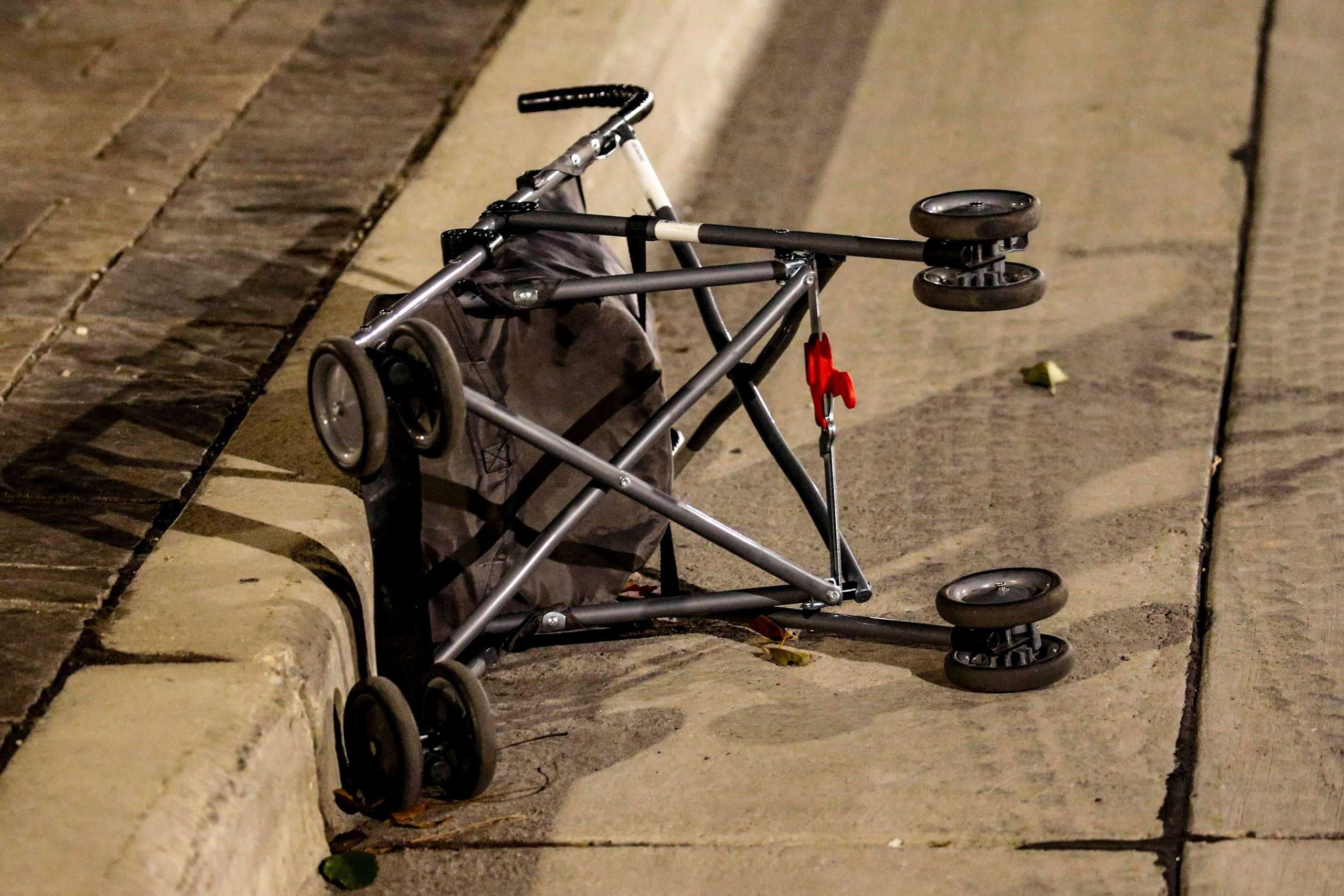 A stroller lays abandoned on the street after a vehicle plowed through the Christmas Parade, leaving multiple people injured in Waukesha, Wisconsin, U.S. November 21, 2021. Scott Ash-USA TODAY NETWORK via REUTERS        NO RESALES. NO ARCHIVES. MANDATORY CREDIT