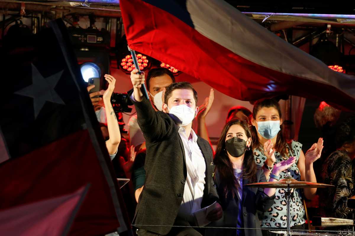 Chile's Presidential candidate Gabriel Boric waves a Chilean flag after the partial results of the first round vote during the presidential elections, in Santiago, Chile, November 21, 2021. REUTERS