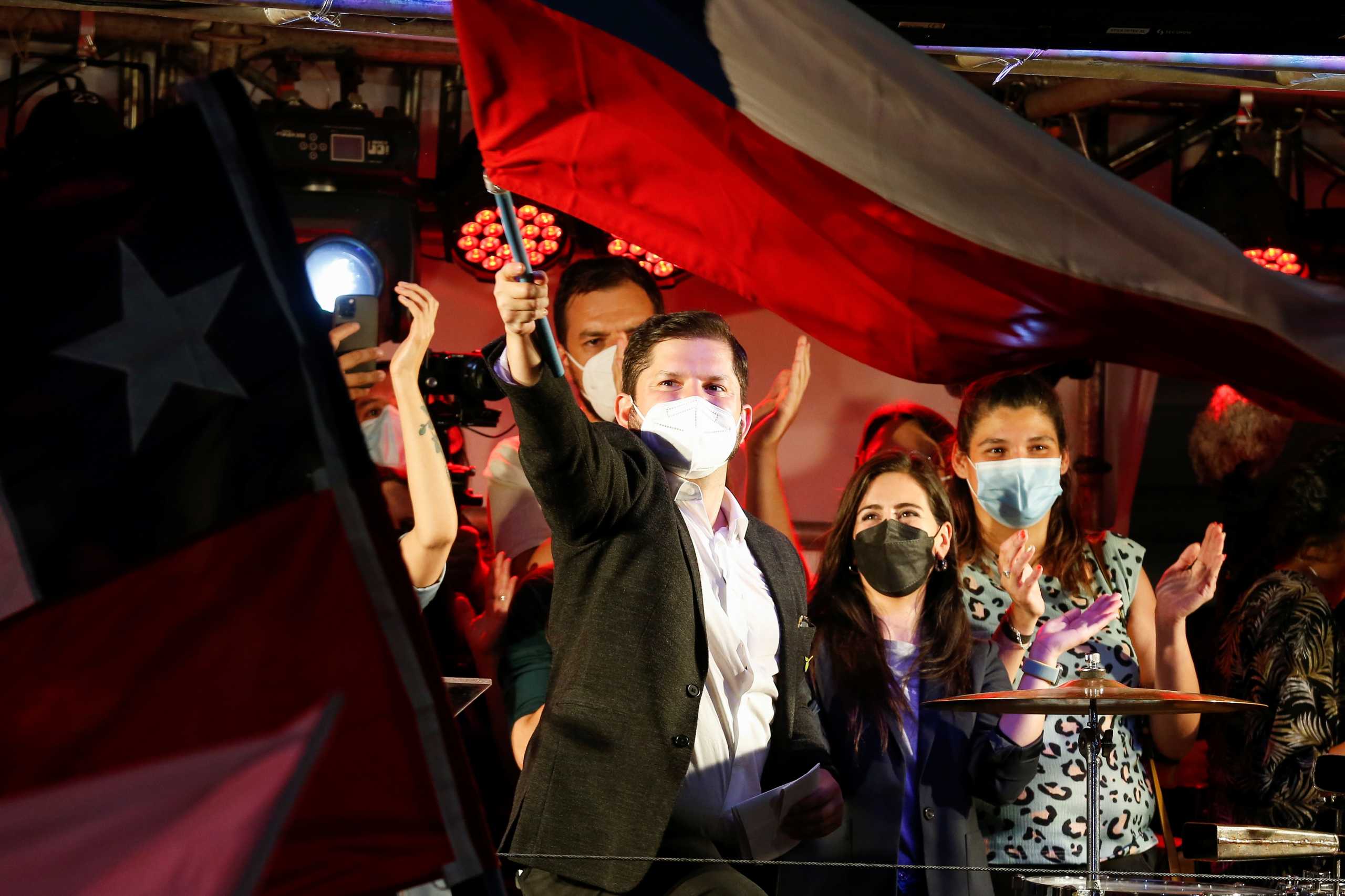 Chile's Presidential candidate Gabriel Boric waves a Chilean flag after the partial results of the first round vote during the presidential elections, in Santiago, Chile, November 21, 2021. REUTERS