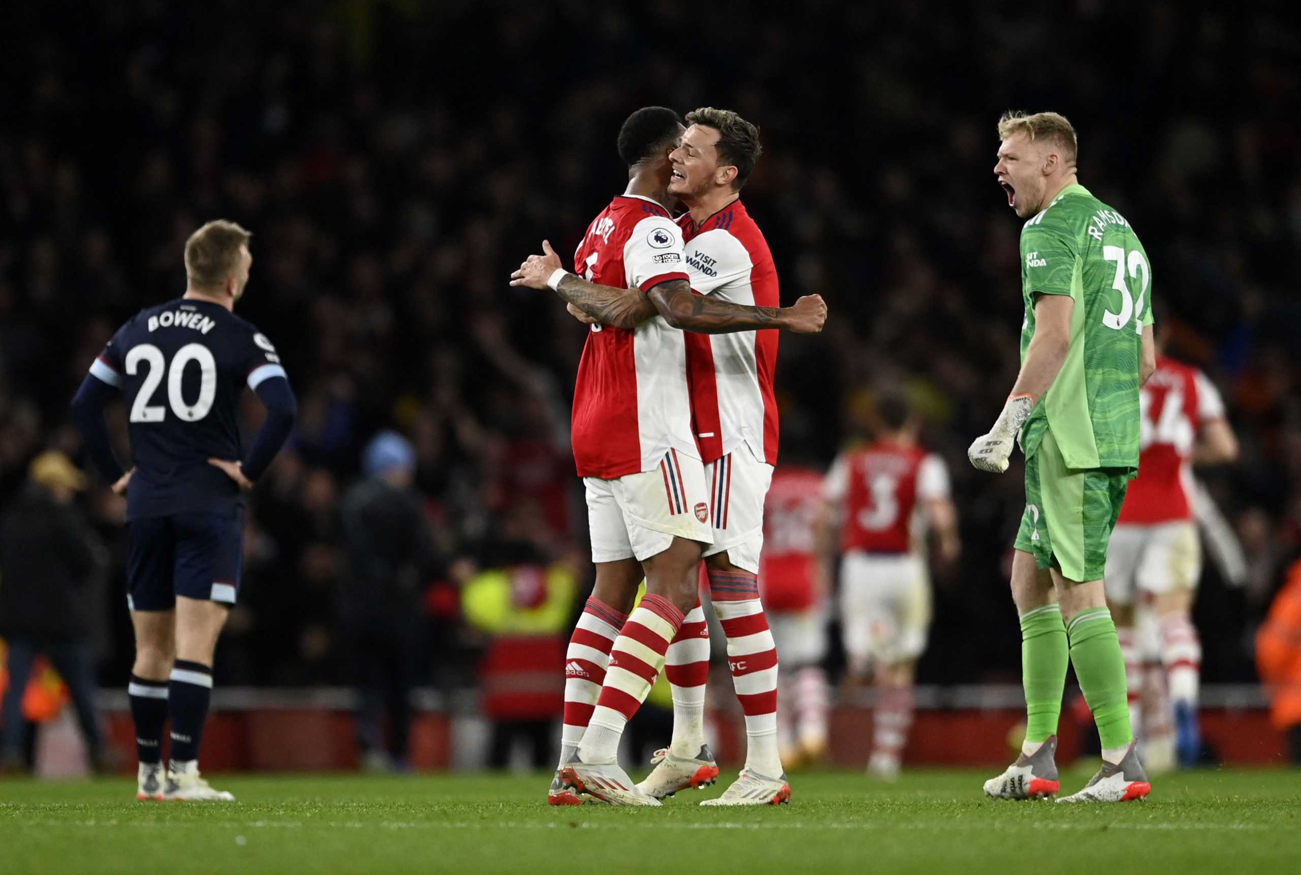 Soccer Football - Premier League - Arsenal v West Ham United - Emirates Stadium, London, Britain - December 15, 2021 Arsenal's Ben White, Aaron Ramsdale and Gabriel celebrate their second goal scored by Emile Smith Rowe REUTERS