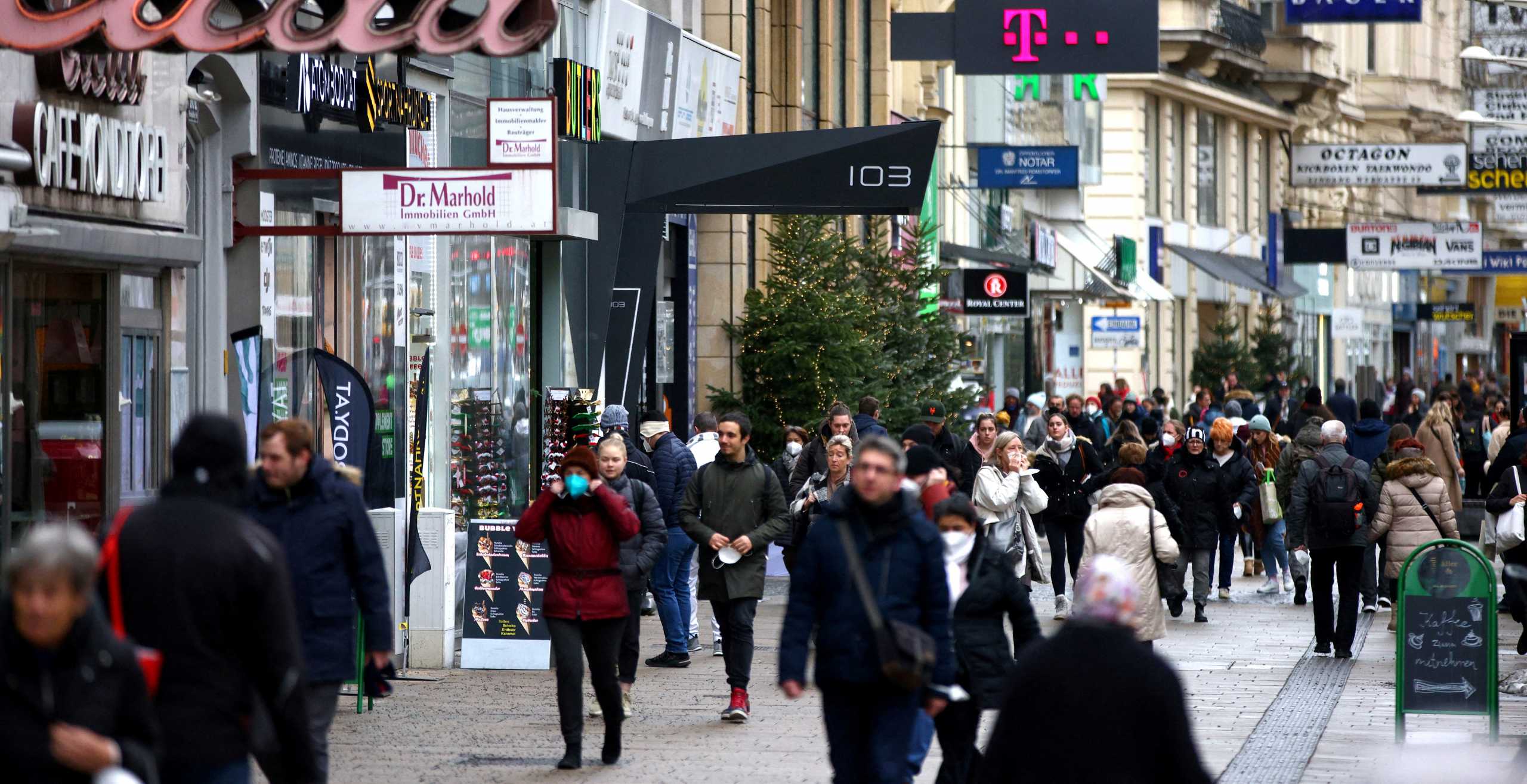 FILE PHOTO: People walk along a shopping street after the fourth full national coronavirus disease (COVID-19) lockdown lifted, in Vienna, Austria, December 13, 2021. REUTERS