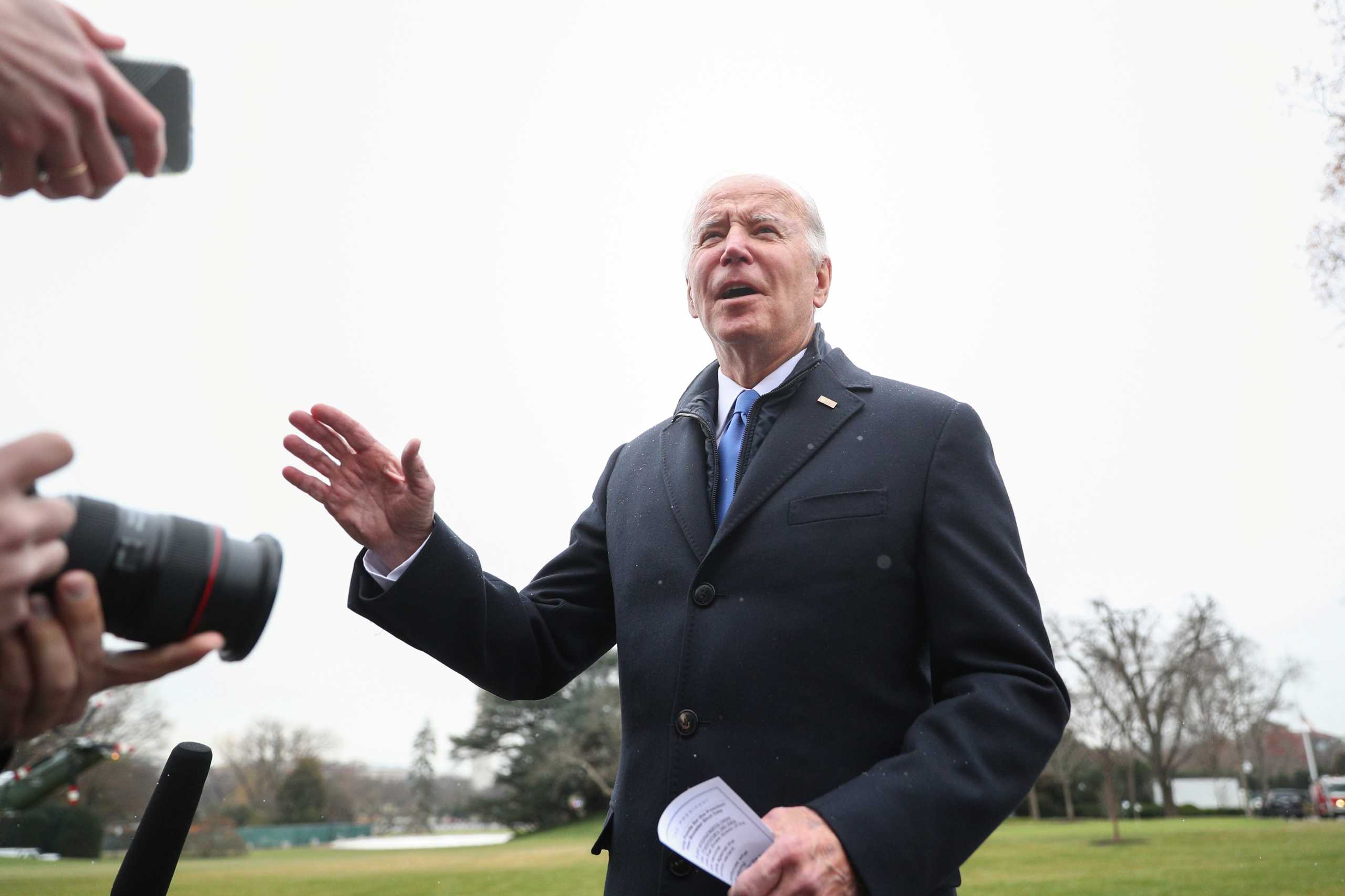 U.S. President Joe Biden speaks to journalists before walking to Marine One at the South Lawn of the White House in Washington, U.S, December 8, 2021. REUTERS