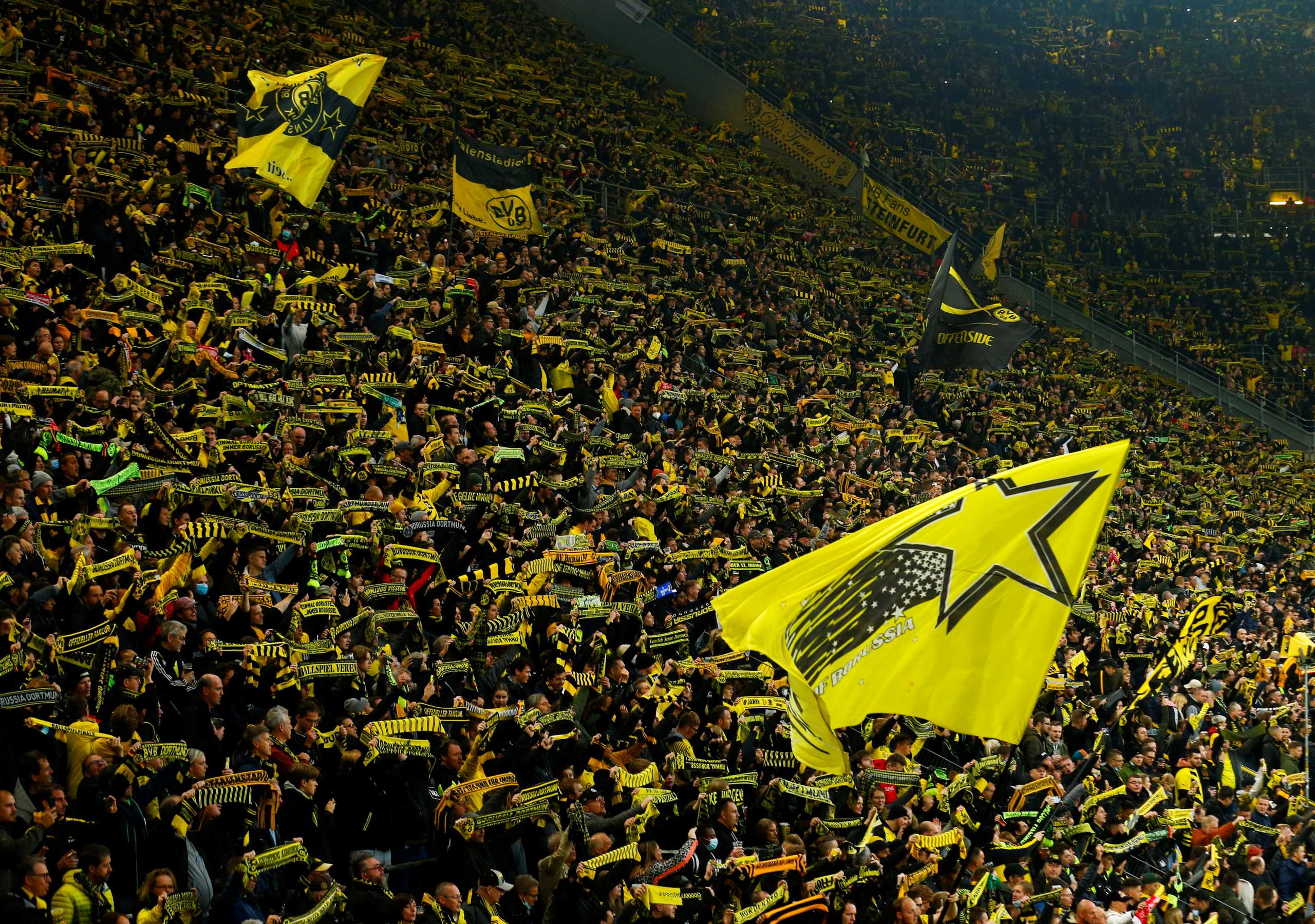 Fans of the football club Borussia Dortmund cheer from the stands of the Signal Iduna Park stadium before the team's Bundesliga match against VfB Stuttgart, as the spread of the coronavirus disease (COVID-19) continues in Dortmund, Germany, November 20, 2021. REUTERS